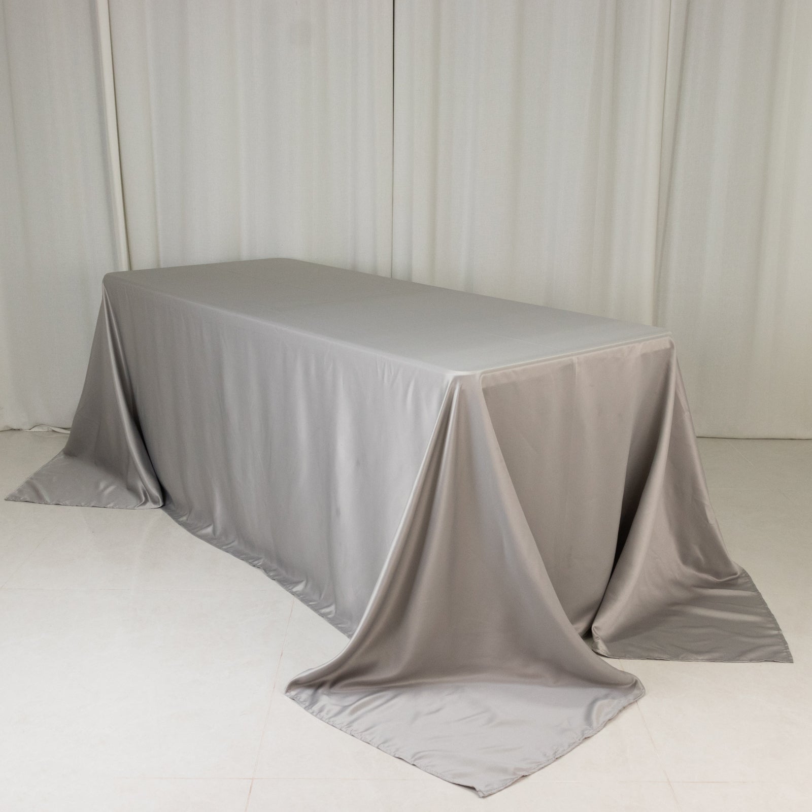 Silver satin tablecloth for a 6-foot table with floor-length drop.