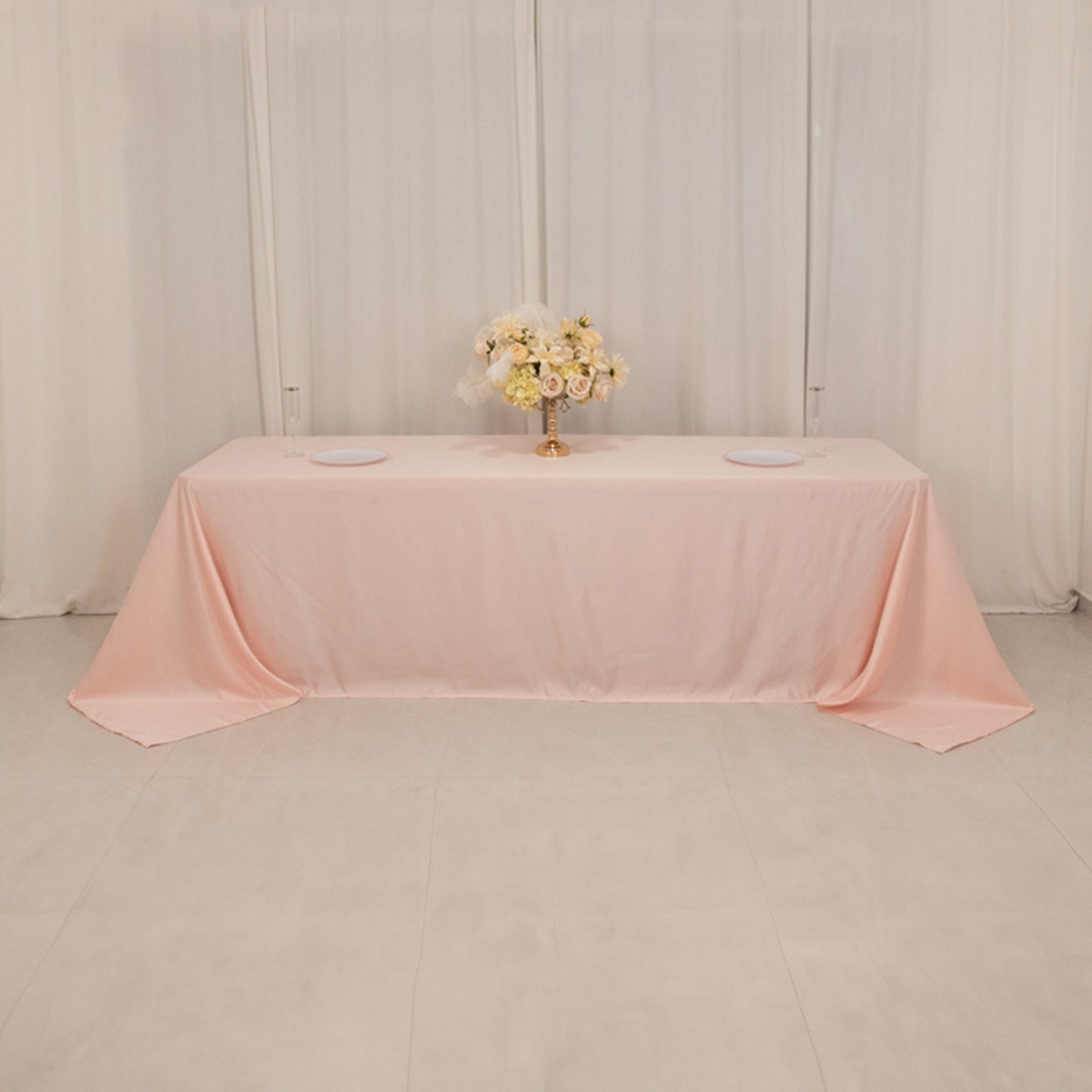 Blush satin tablecloth for 8-foot table with floor-length drop.
