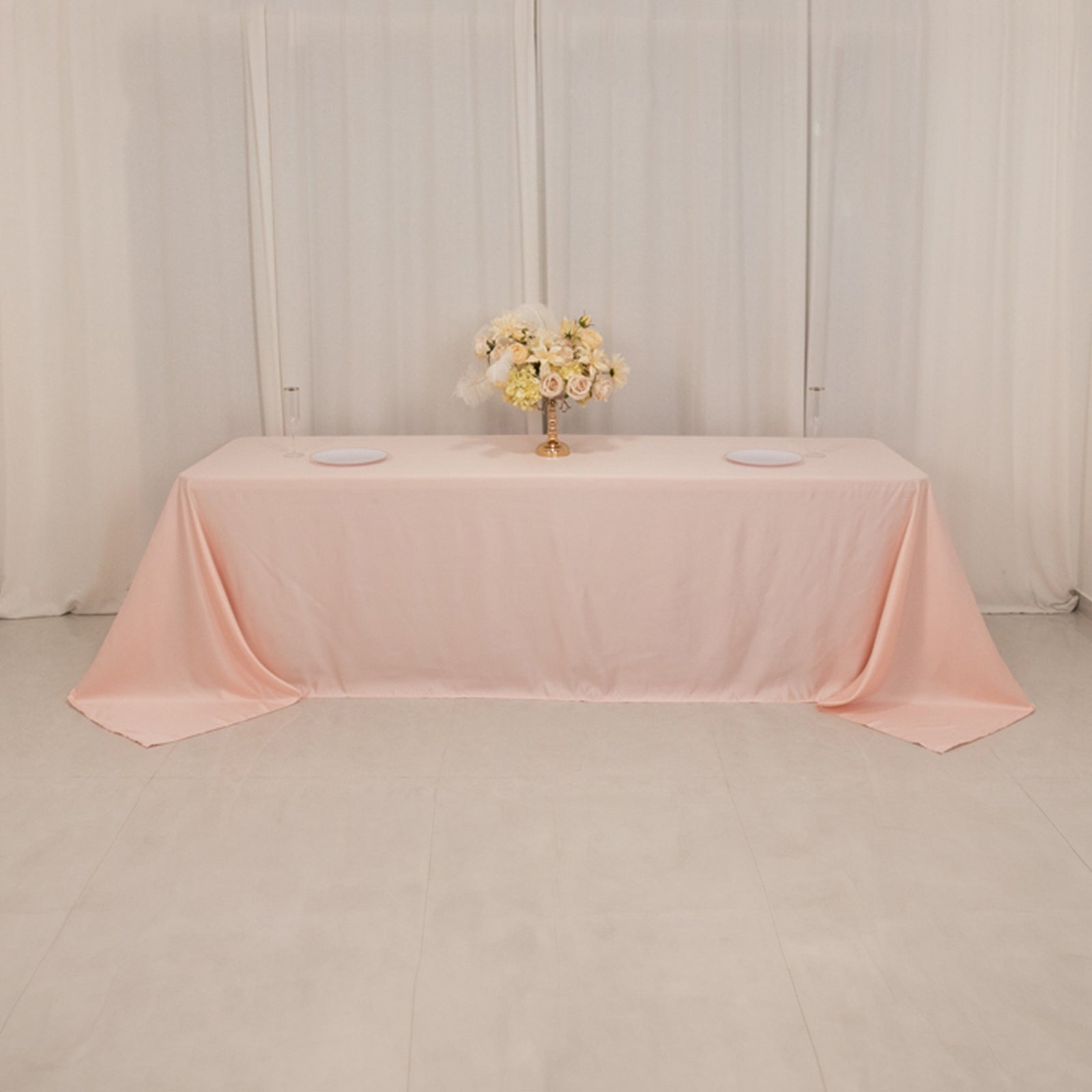 Blush satin tablecloth for 8-foot table with floor-length drop.