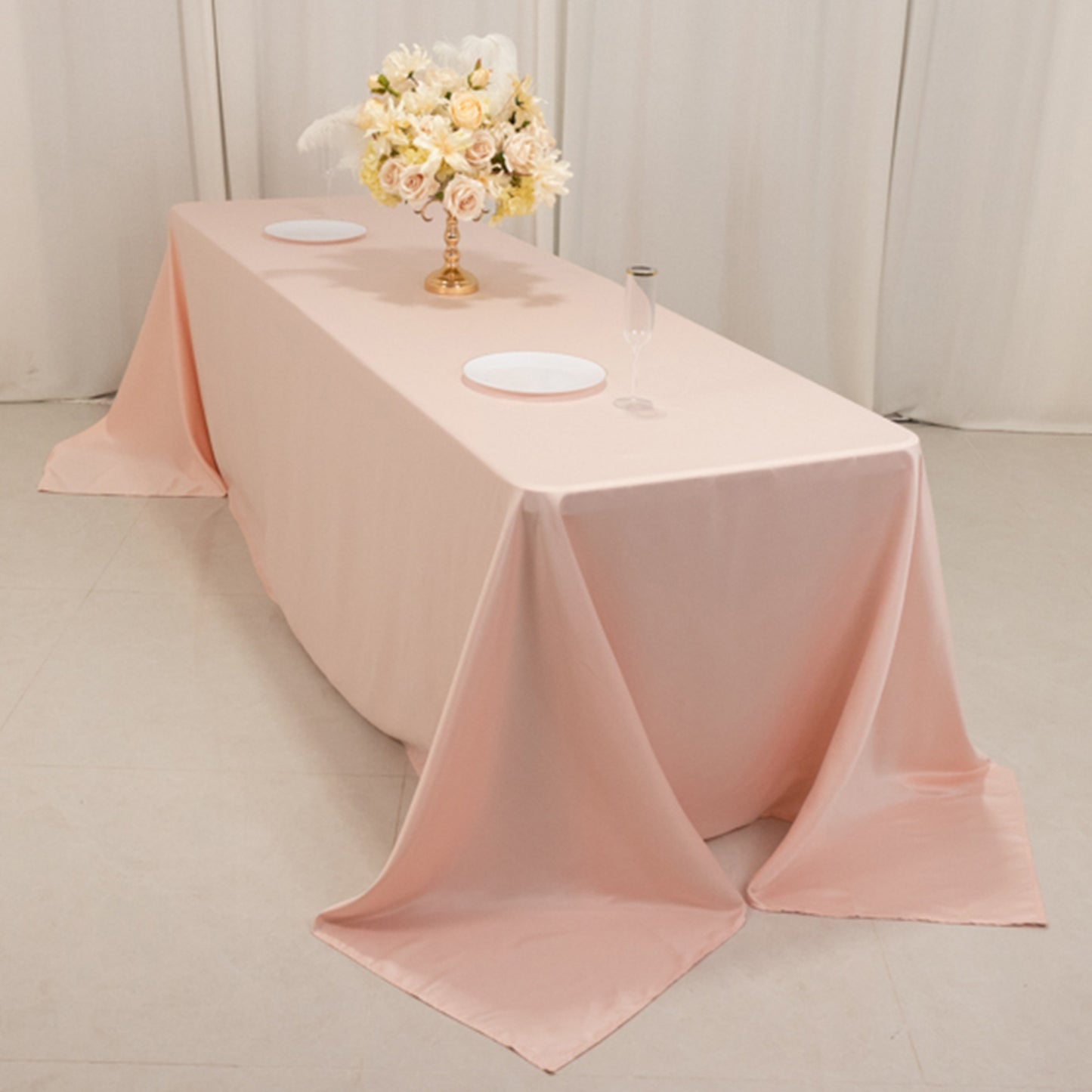 Blush satin tablecloth for 8-foot table with floor-length drop.