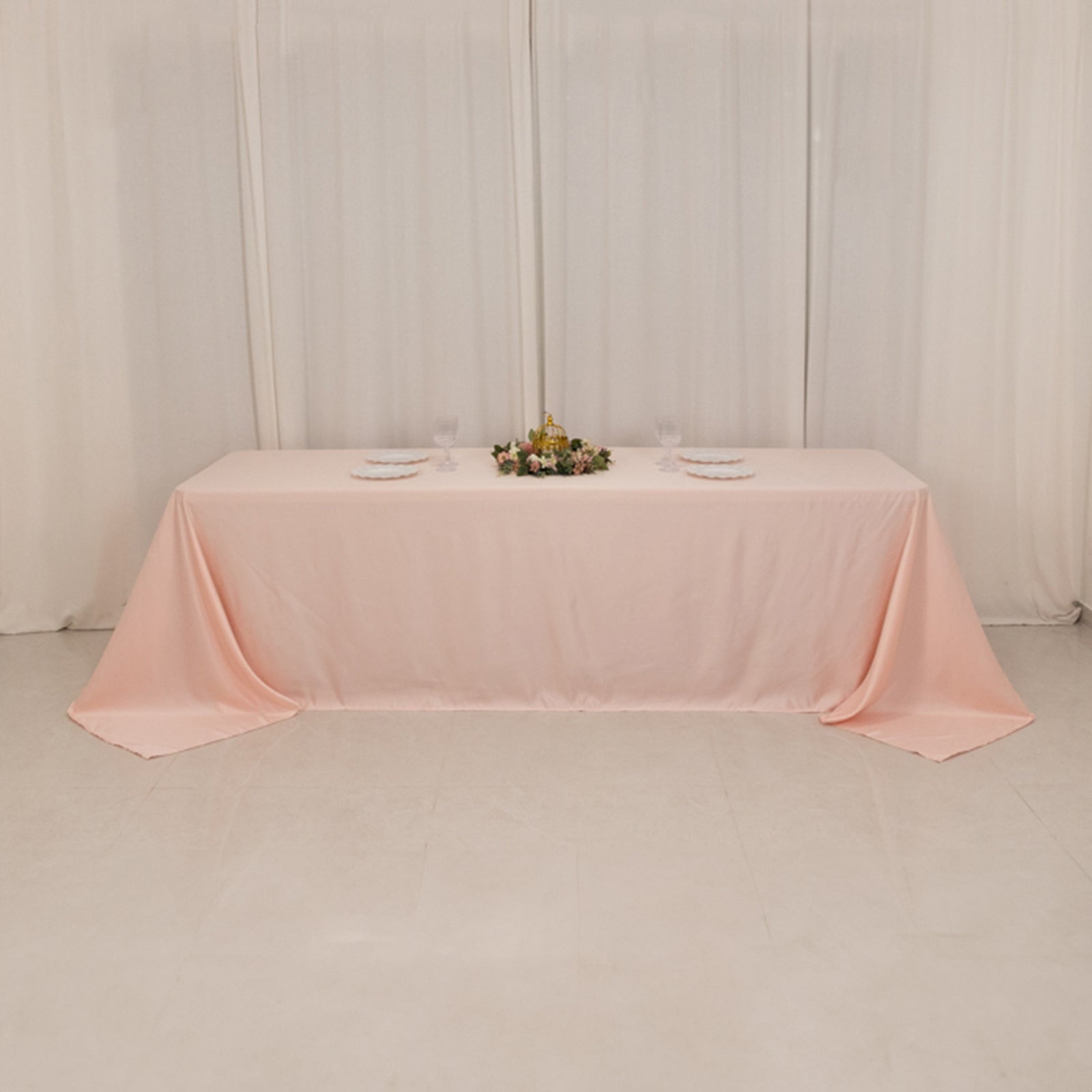 Blush satin tablecloth for an 8-foot table with a floor-length drop.