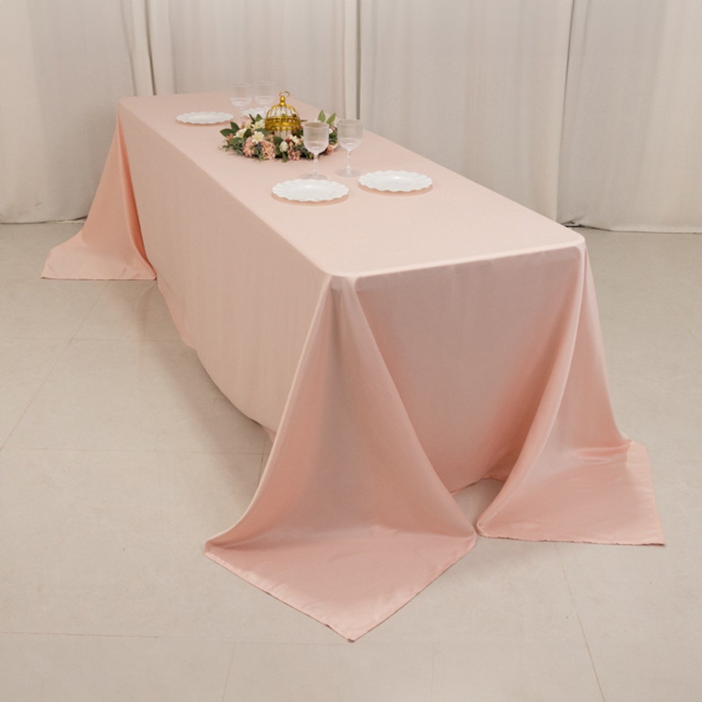 Blush seamless satin tablecloth for 8-foot table with floor-length drop.