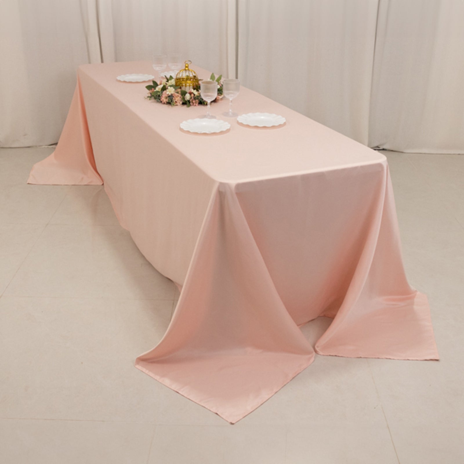 Blush seamless satin tablecloth for 8-foot table with floor-length drop.