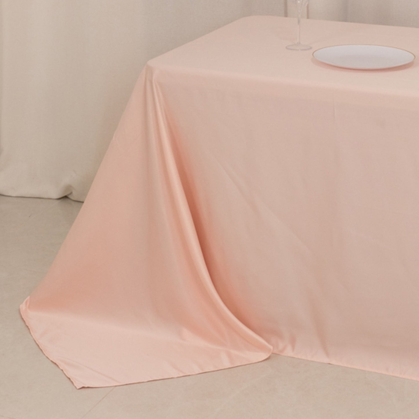 Blush satin tablecloth for 8-foot table with floor-length drop.