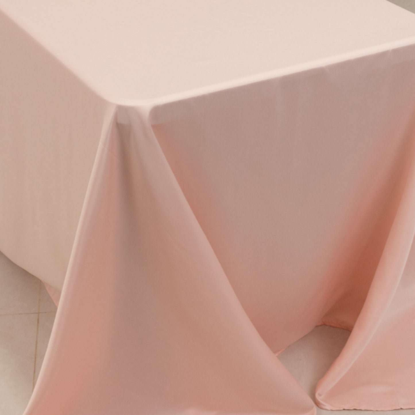Blush satin tablecloth for 8-foot table with floor-length drop.