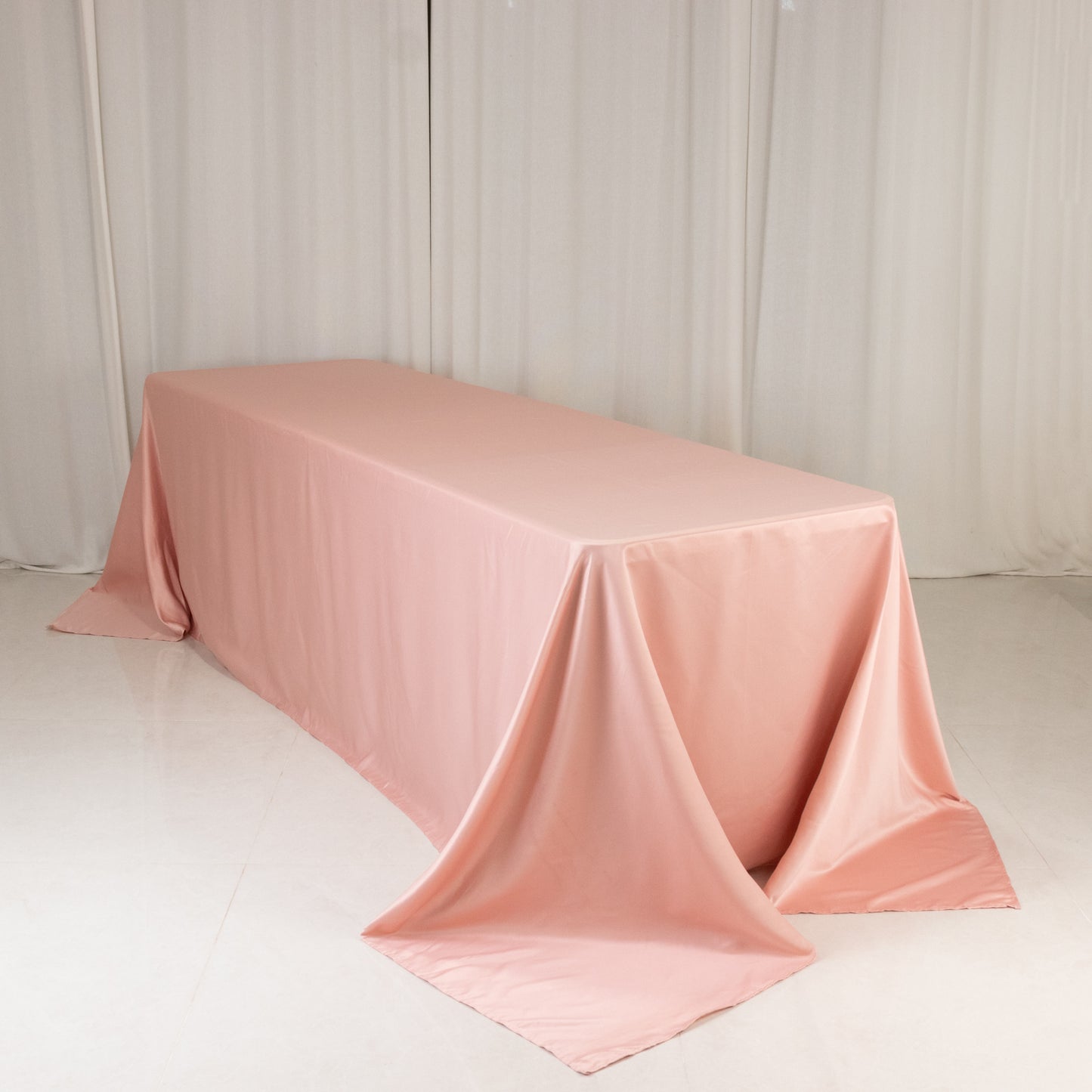 Dusty rose satin rectangle tablecloth for 8-foot table with floor-length drop.