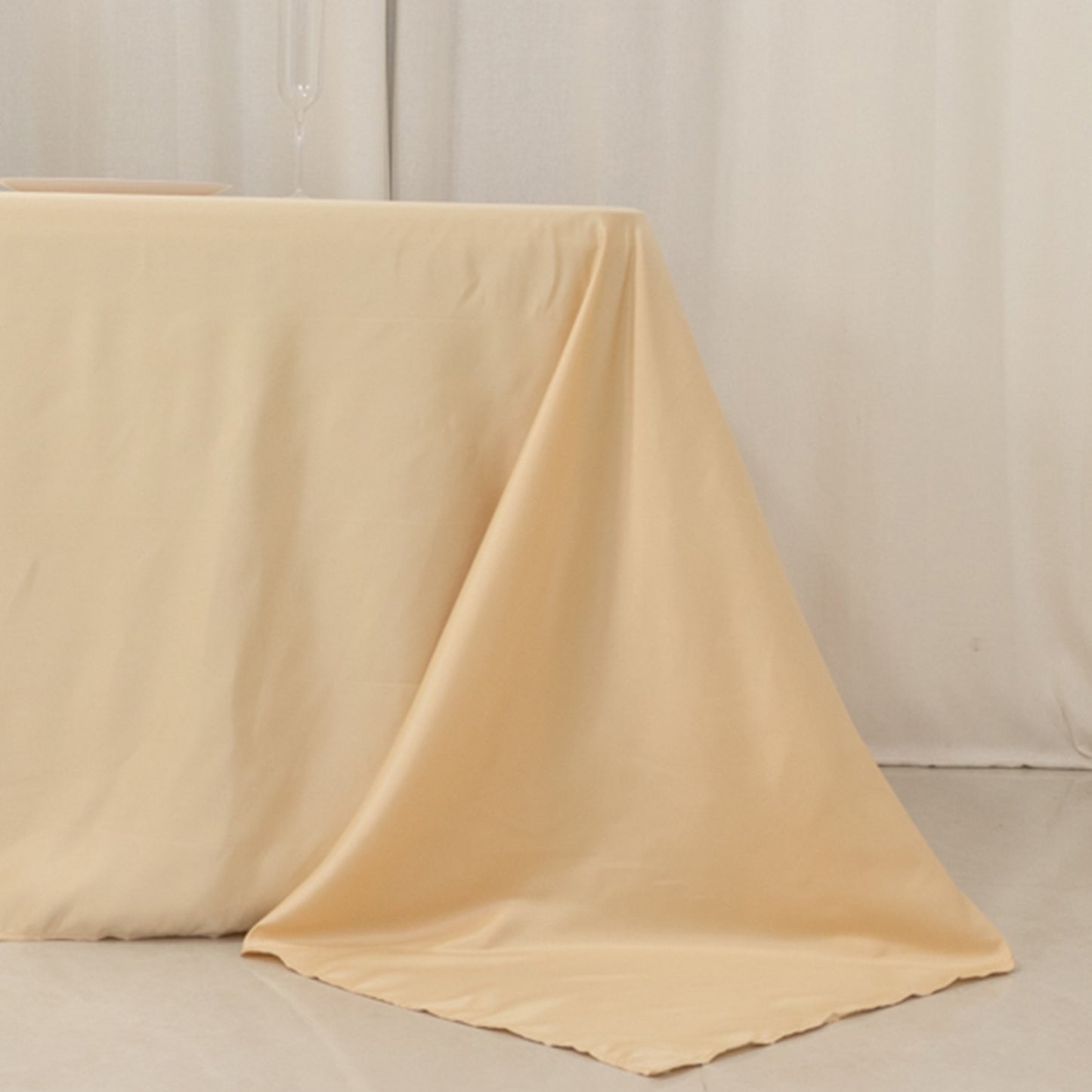 Beige seamless satin tablecloth for 8-foot table with floor-length drop.