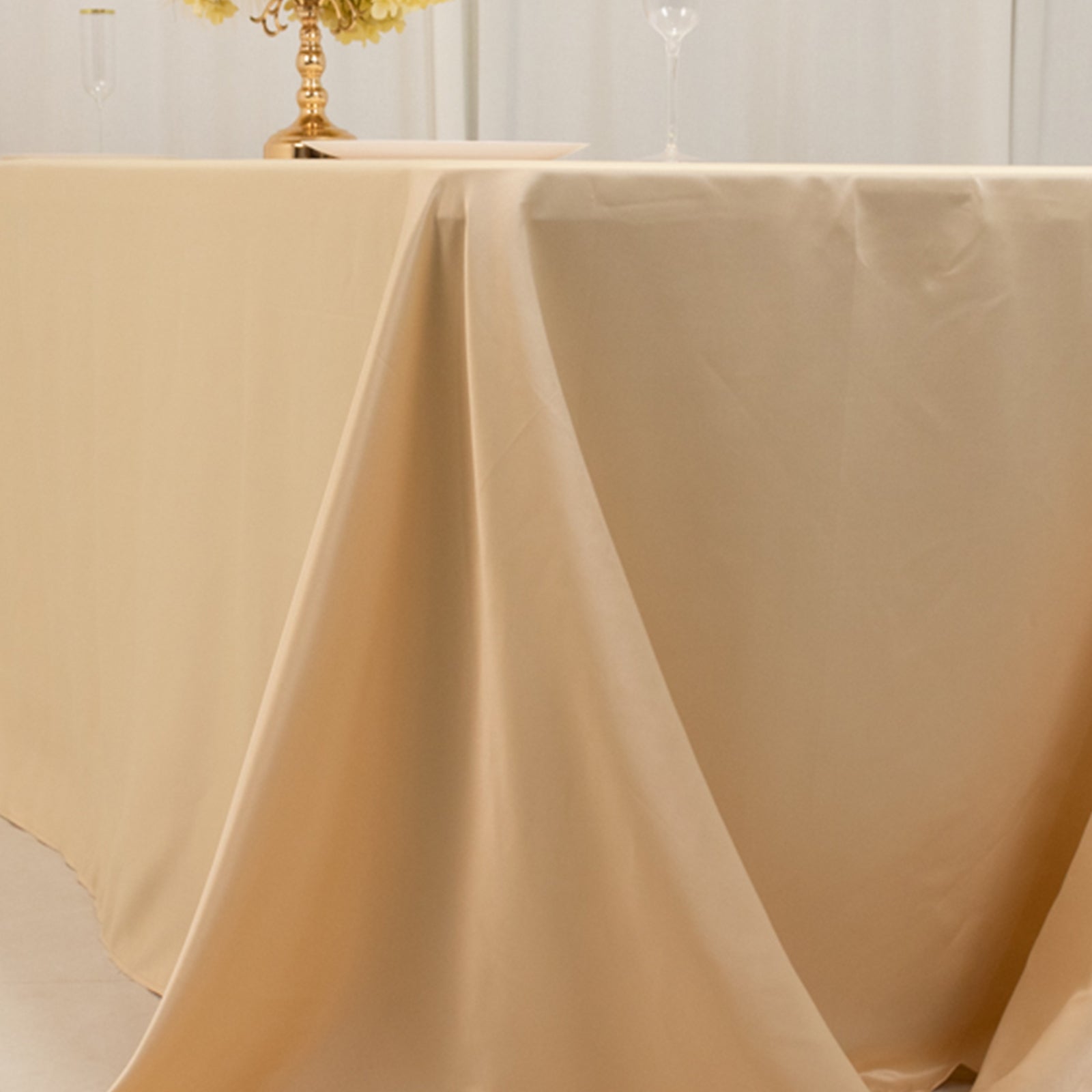 Beige satin tablecloth draped elegantly over an 8-foot table.
