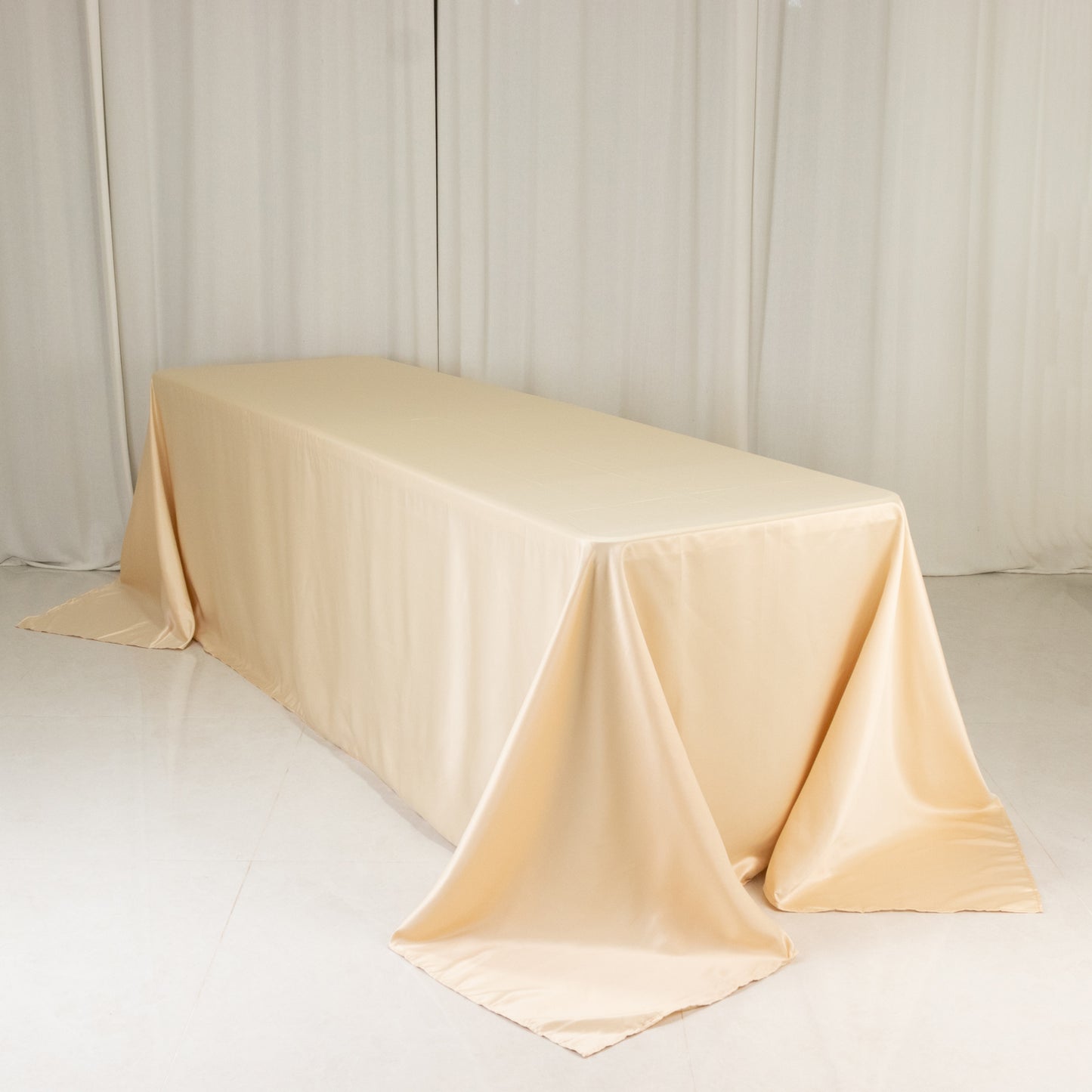Beige seamless satin tablecloth for 8-foot table with floor-length drop.