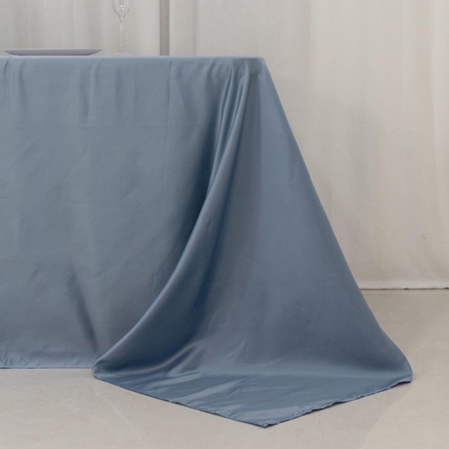 Dusty blue seamless satin tablecloth for 8-foot table with floor-length drop.