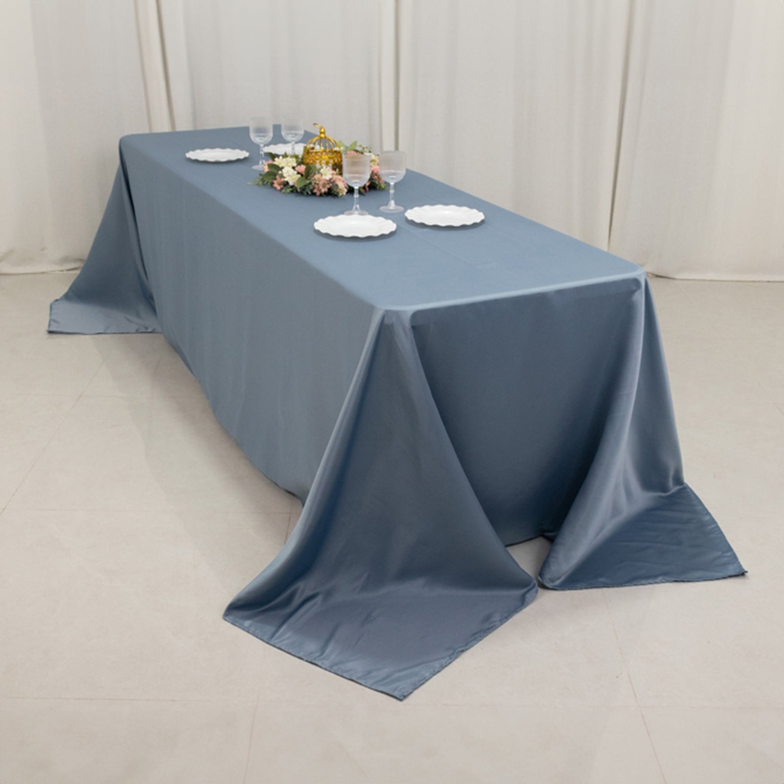 Dusty blue satin tablecloth draping elegantly over an 8-foot table.