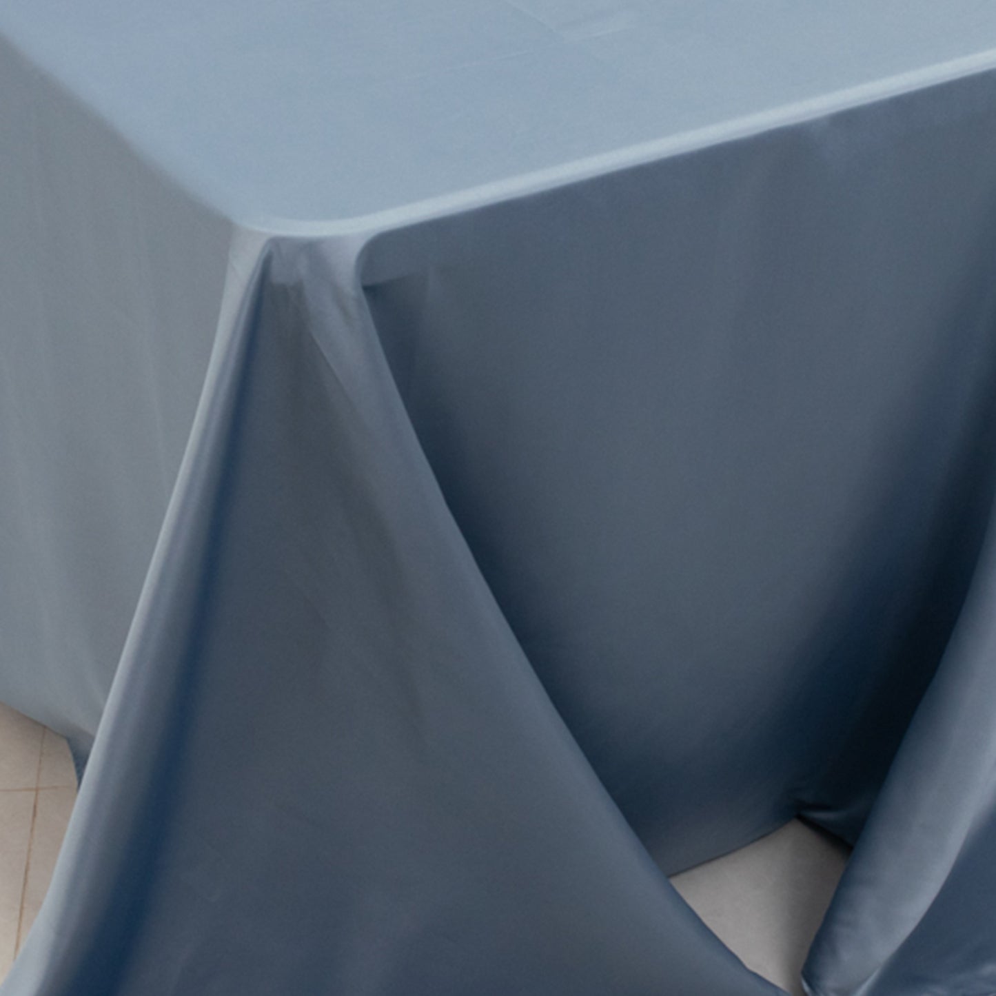 Dusty blue seamless satin tablecloth for 8-foot table with floor-length drop.