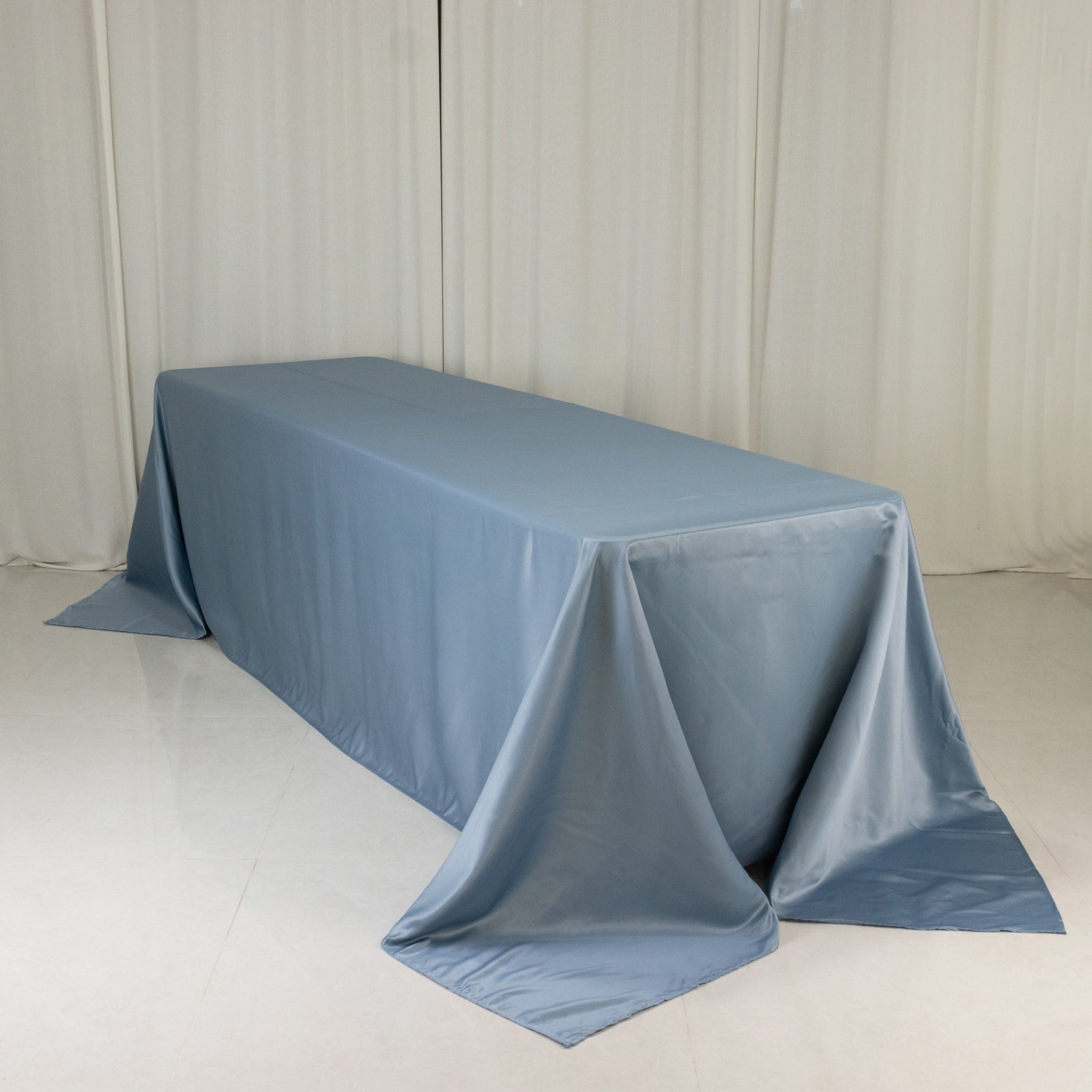 Dusty blue satin tablecloth for 8-foot table with floor-length drop.