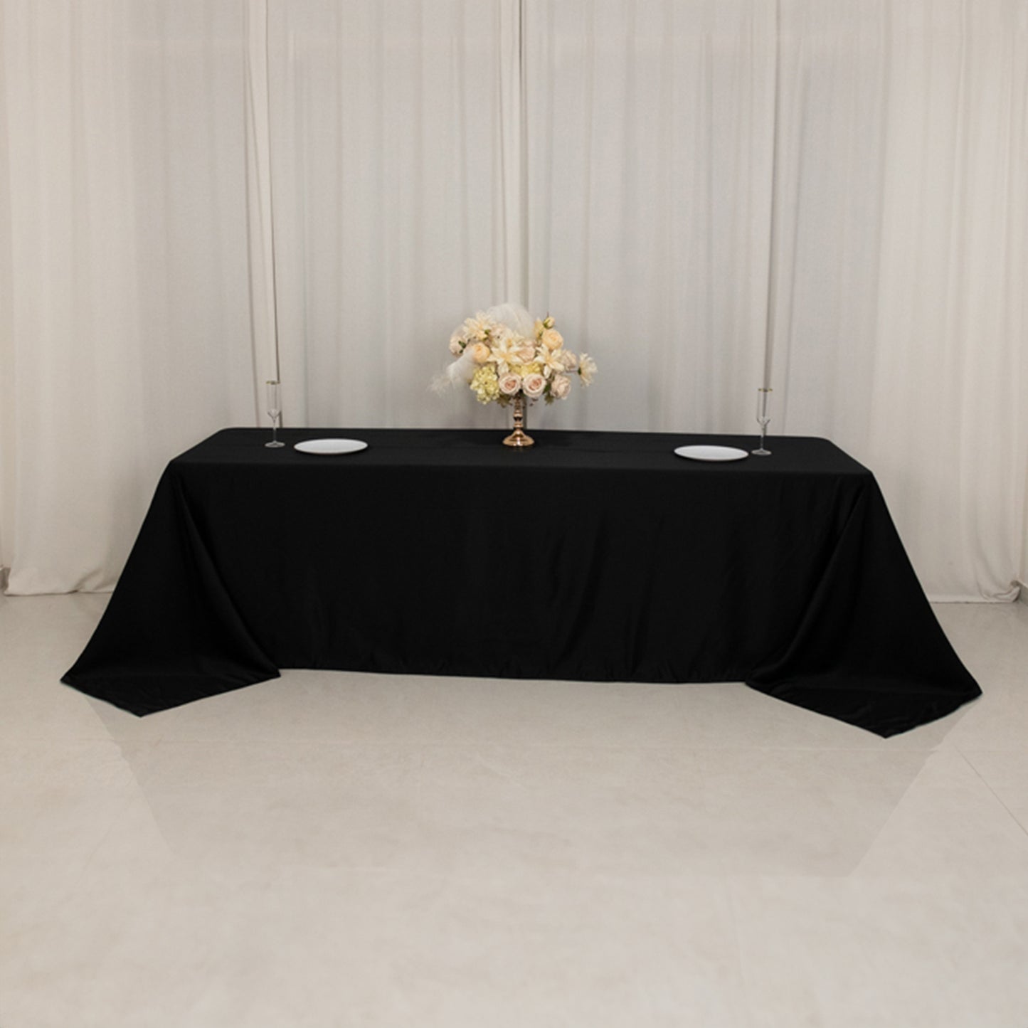 Black seamless satin tablecloth for 8-foot table with floor-length drop.