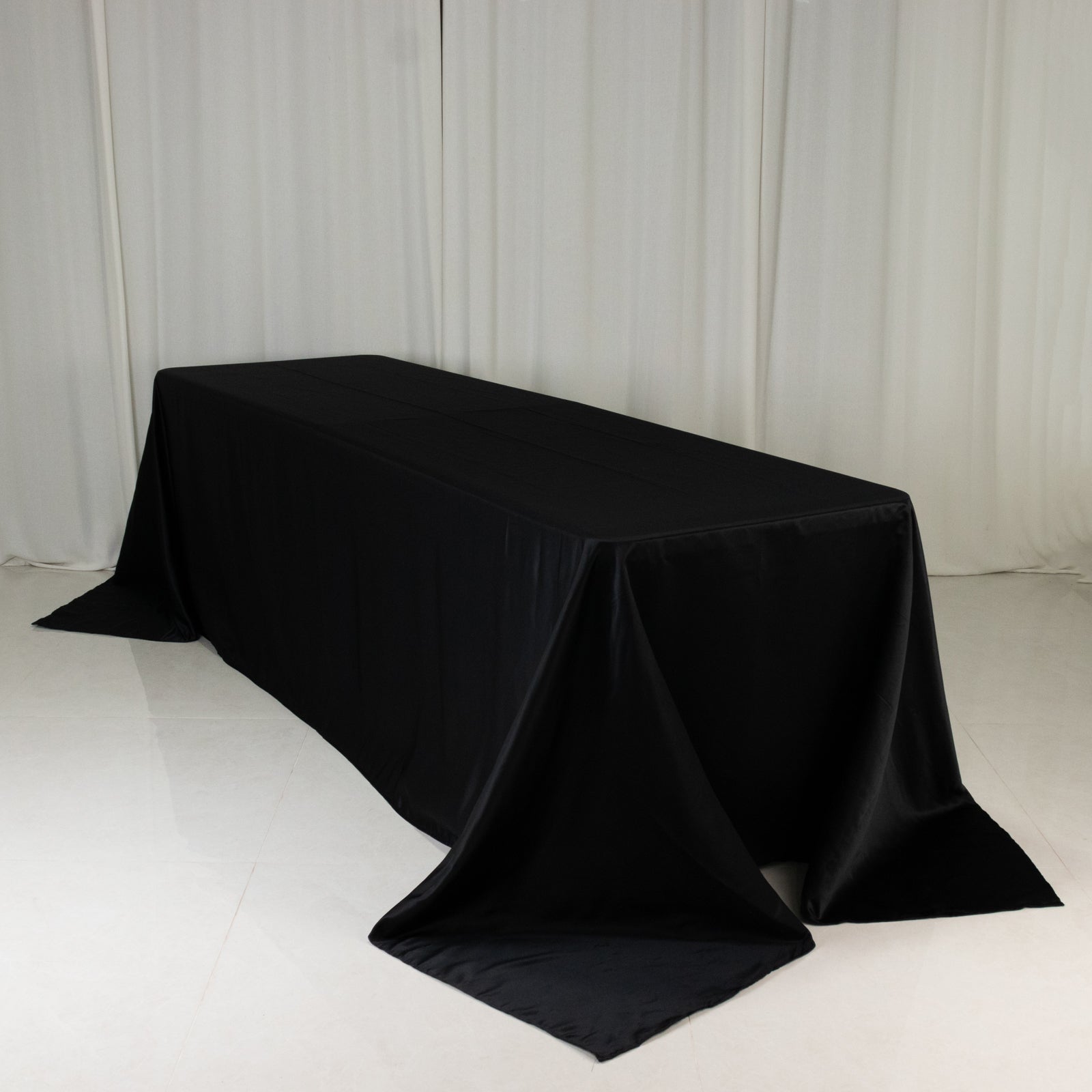 Black satin tablecloth for 8-foot table with floor-length drop.