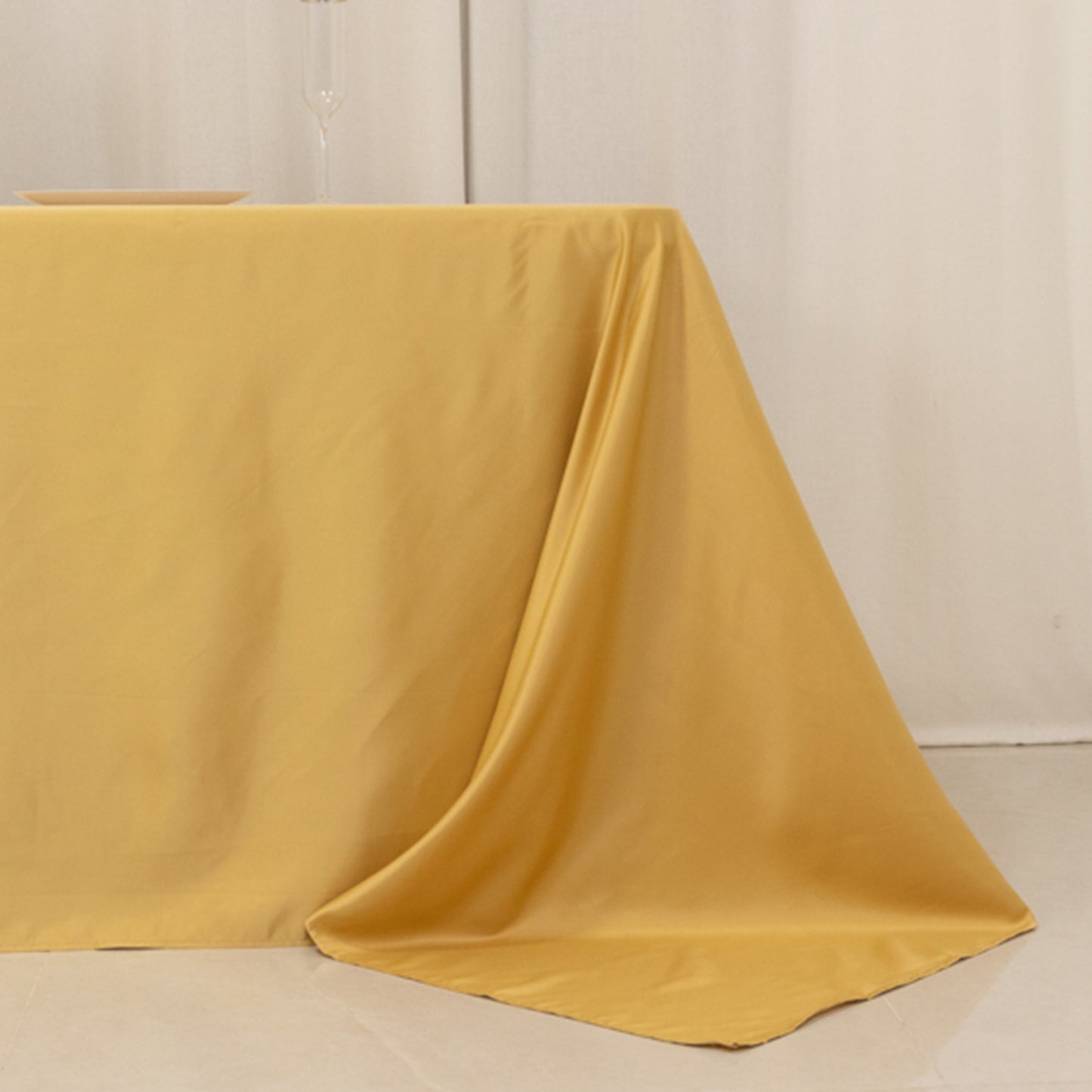 Champagne satin tablecloth for 8-foot table with floor-length drop.