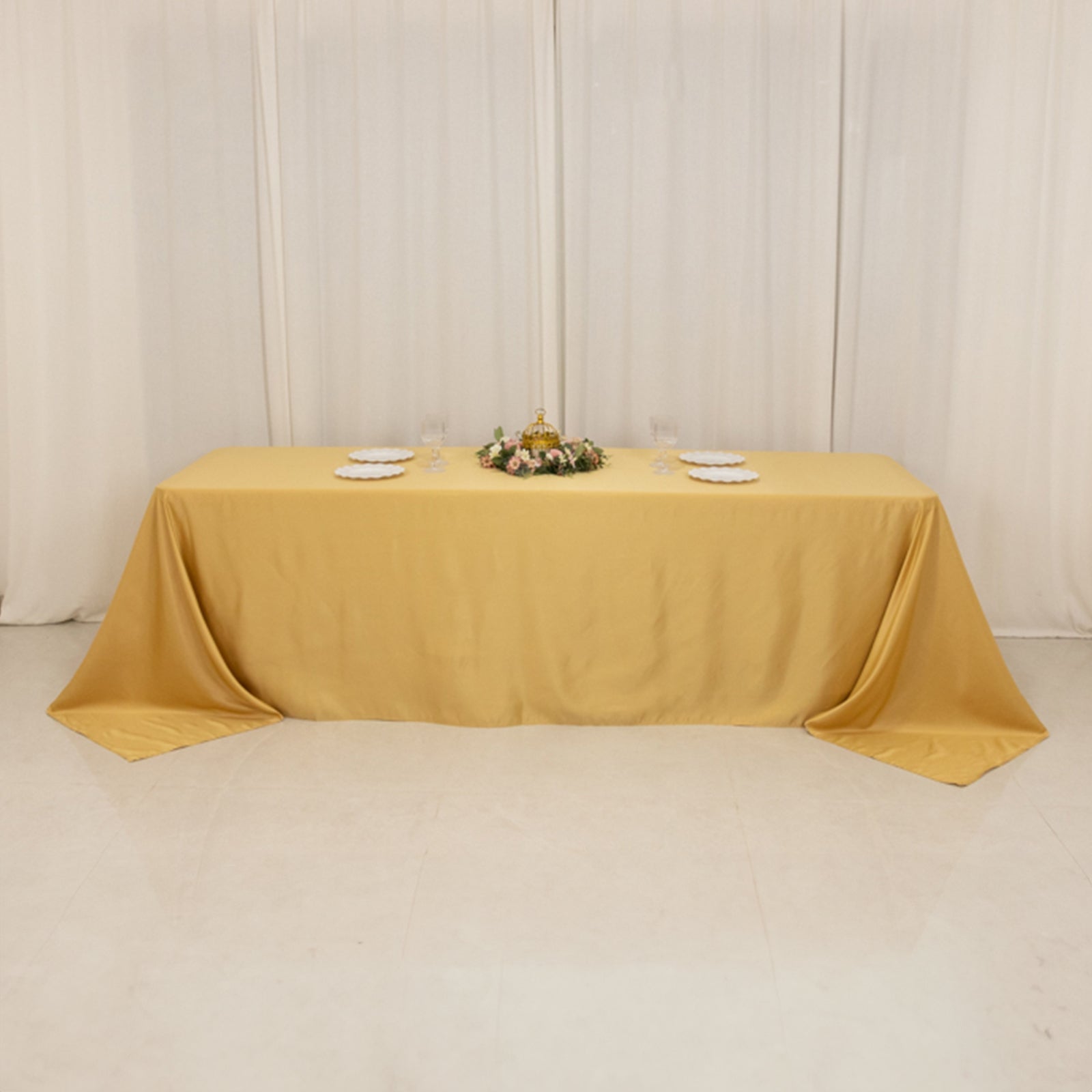 Champagne satin tablecloth for 8-foot table with floor-length drop.