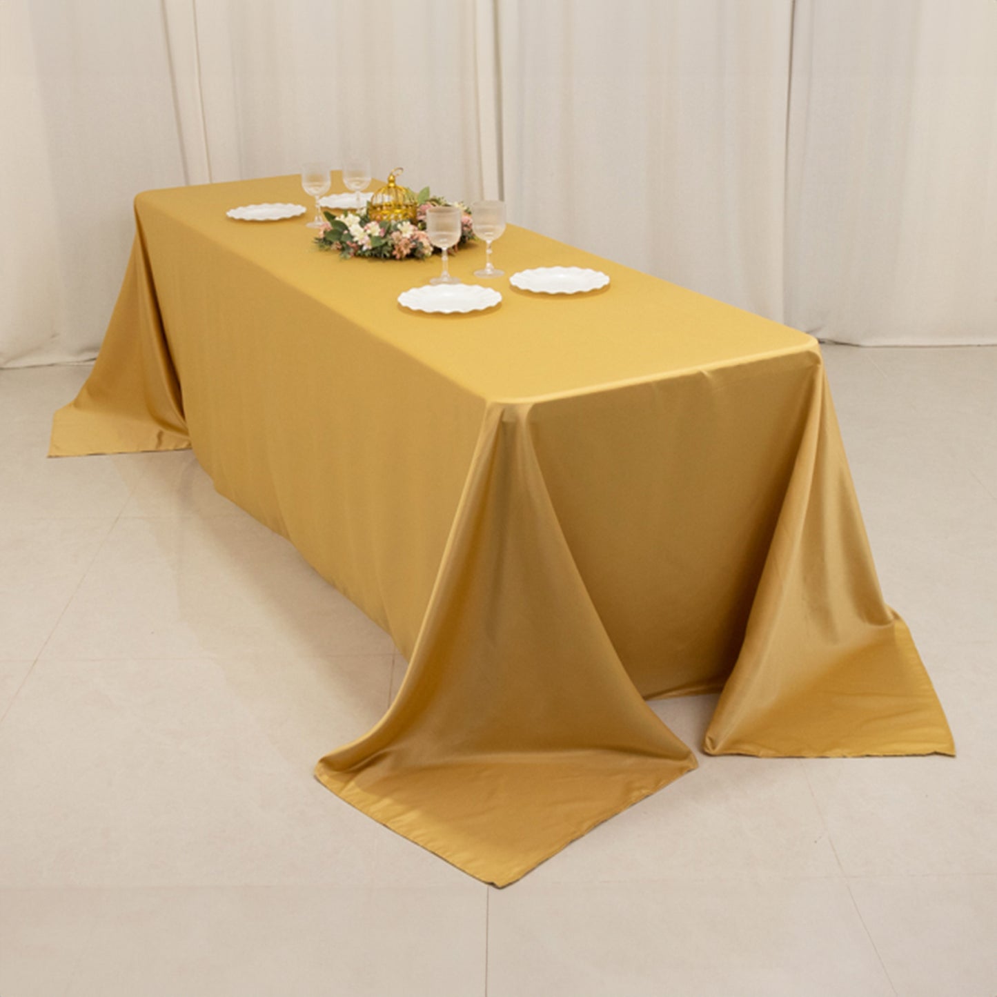 Champagne satin tablecloth draping elegantly over an 8-foot table.