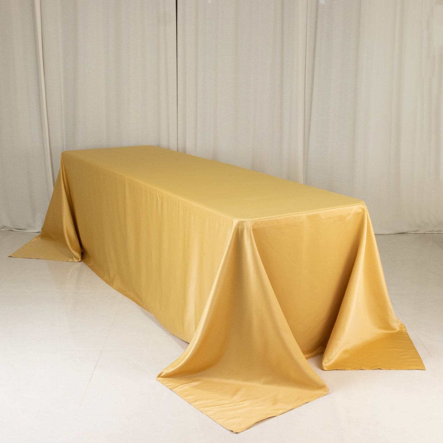 Champagne satin tablecloth for 8-foot table with floor-length drop.