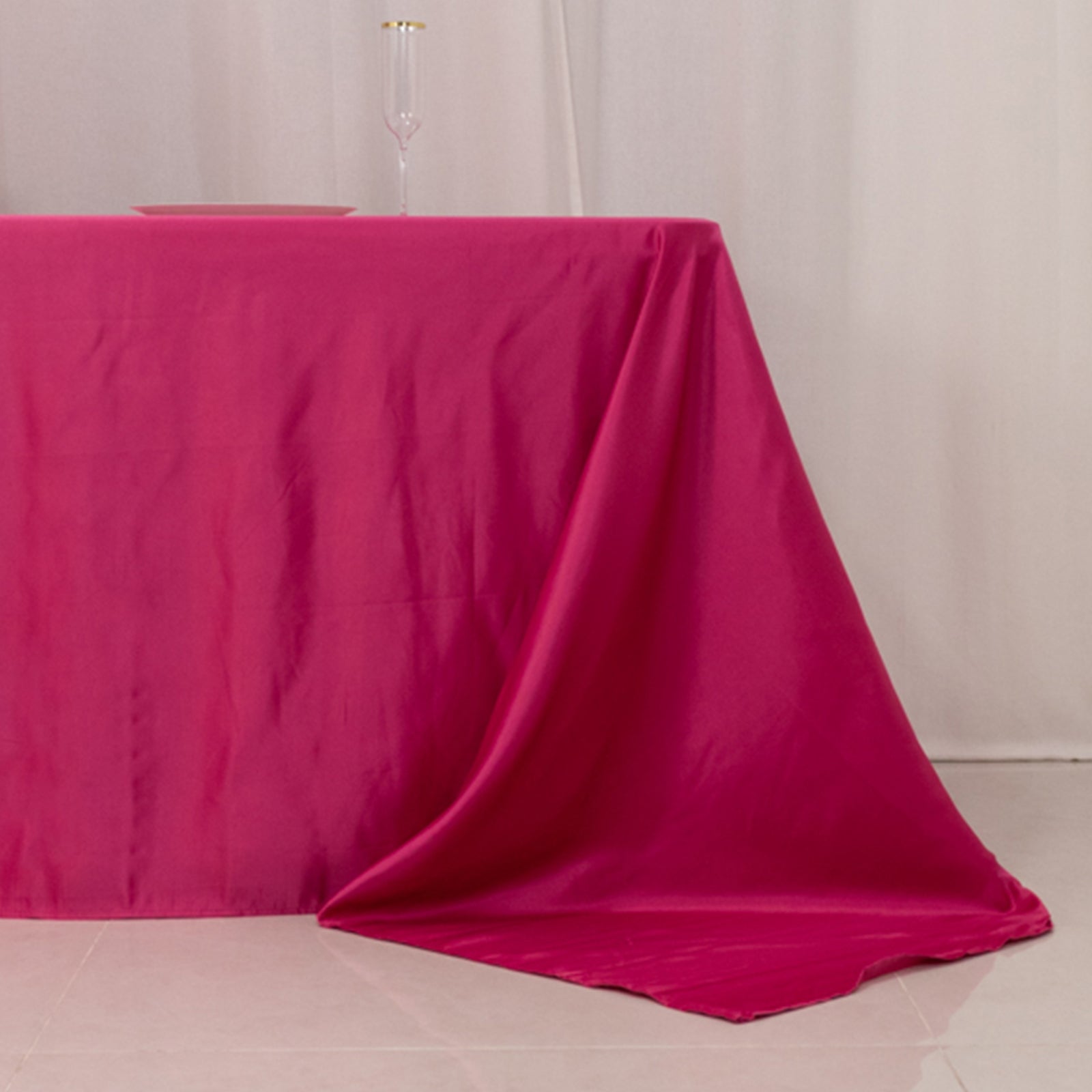 Fuchsia satin tablecloth for 8-foot table with floor-length drop.