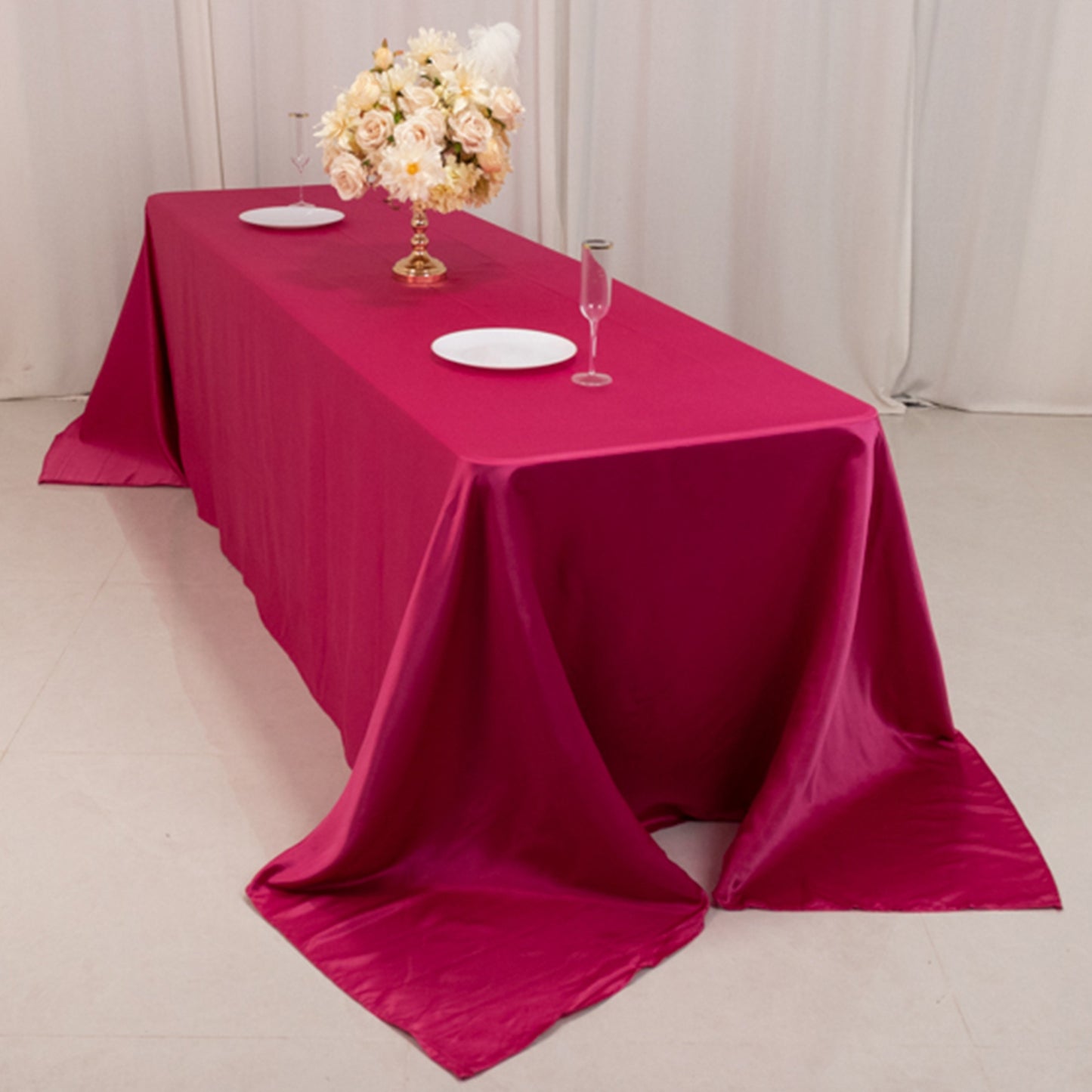 Fuchsia satin tablecloth for an 8-foot table with floor-length drop.