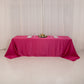 Fuchsia satin rectangle tablecloth for 8-foot table with floor-length drop.