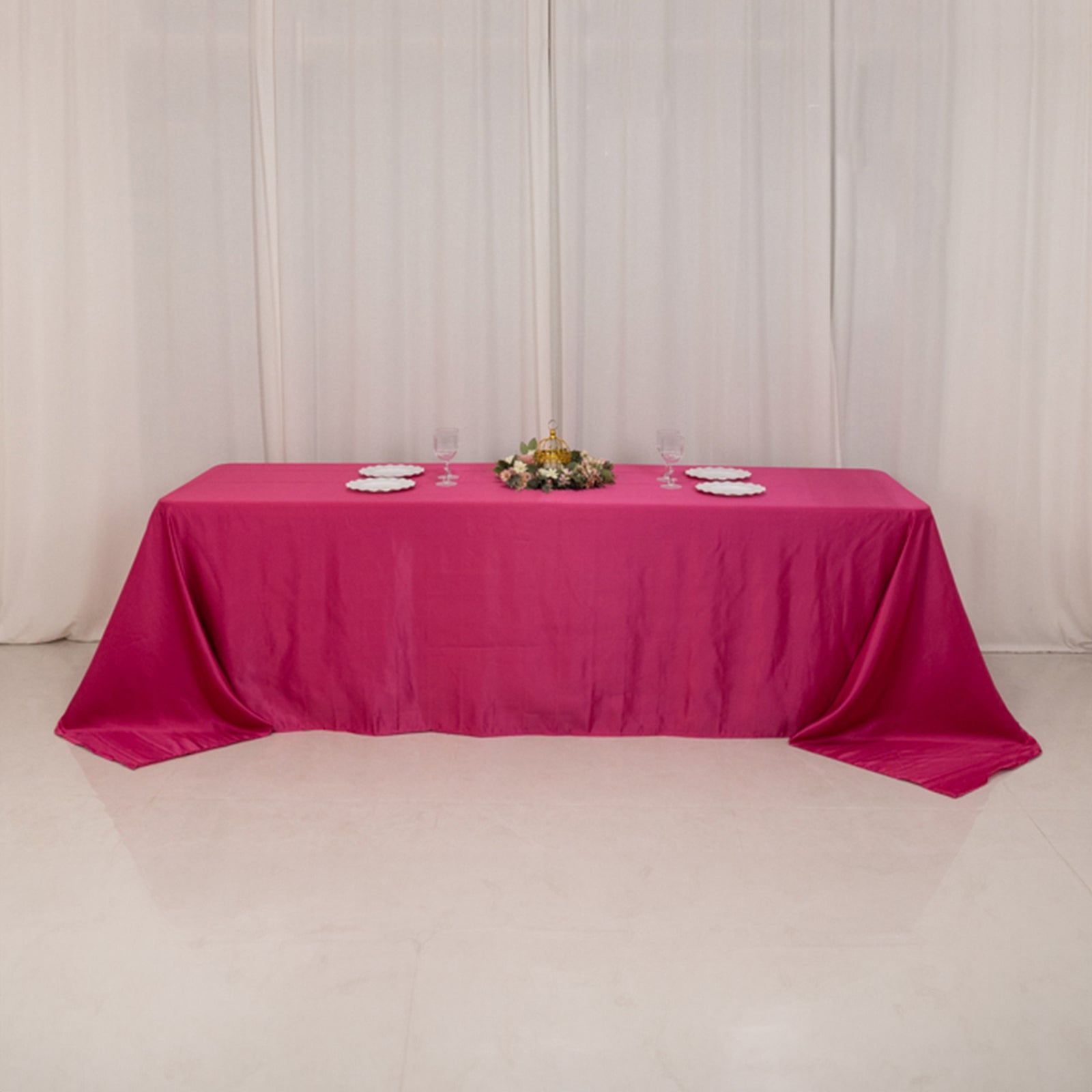 Fuchsia satin rectangle tablecloth for 8-foot table with floor-length drop.