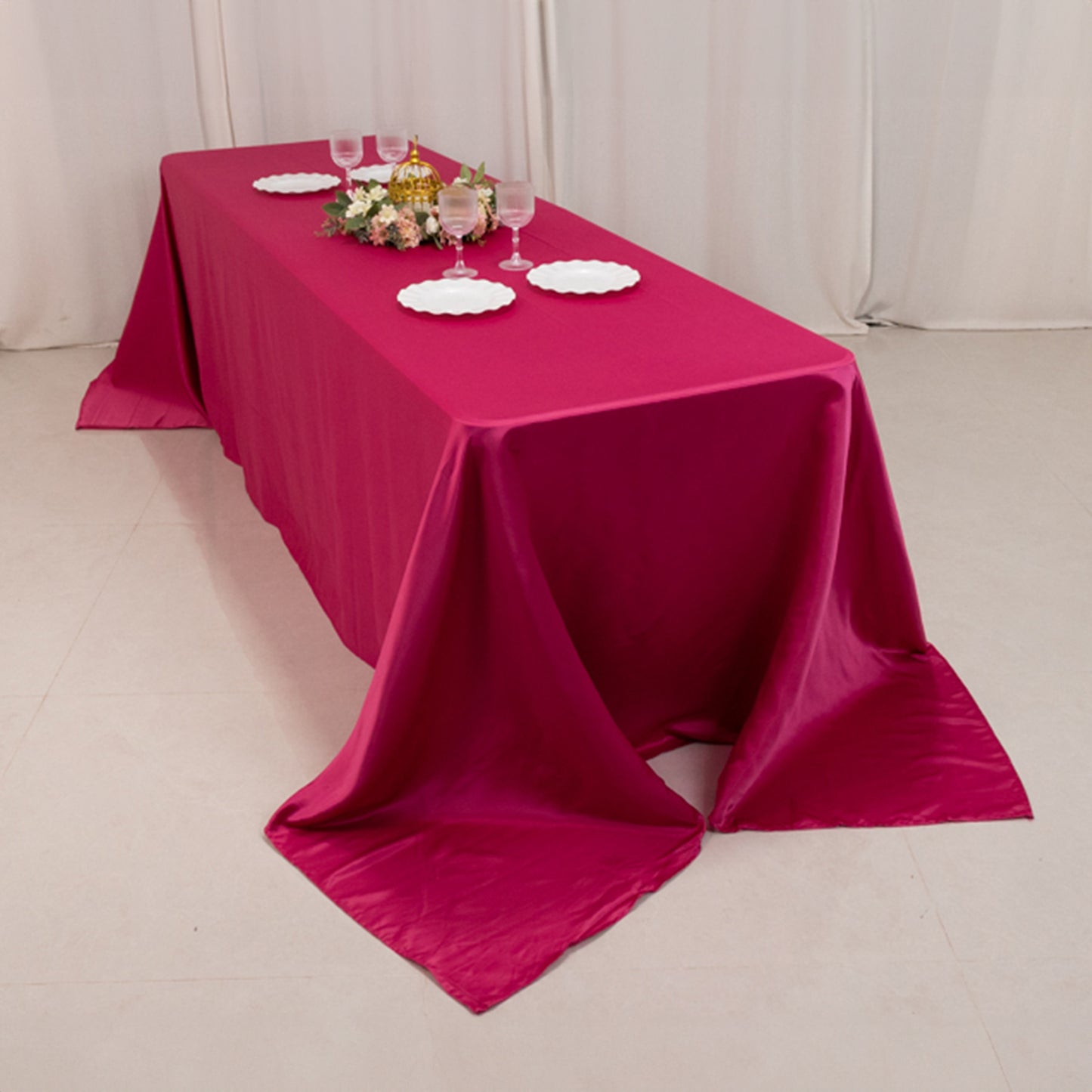 Fuchsia satin tablecloth for 8-foot table with floor-length drop.