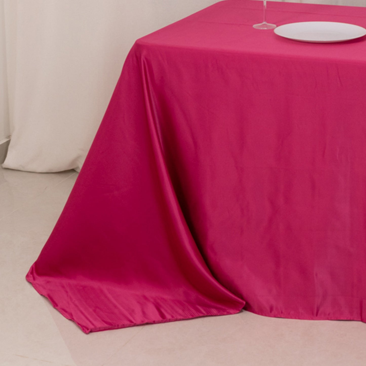 Fuchsia seamless satin tablecloth for 8-foot table with floor-length drop.