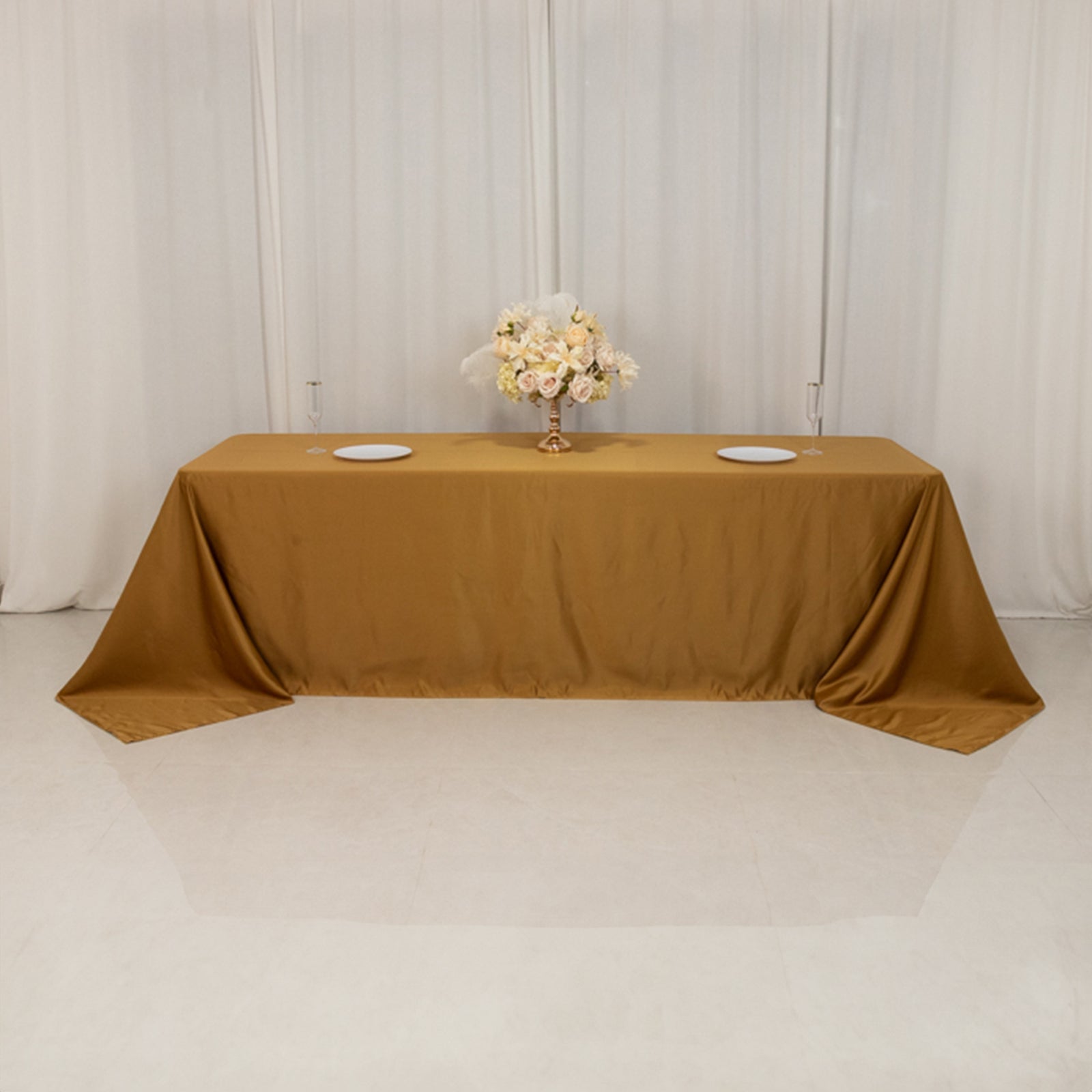 Gold rectangular tablecloth on an 8-foot table with floor-length drop.