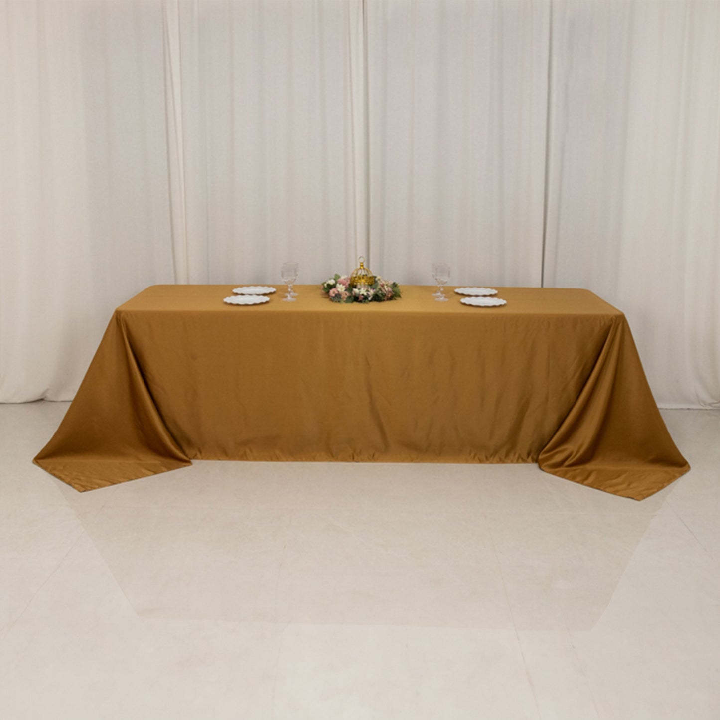 Gold seamless satin tablecloth for an 8-foot table with floor-length drop.