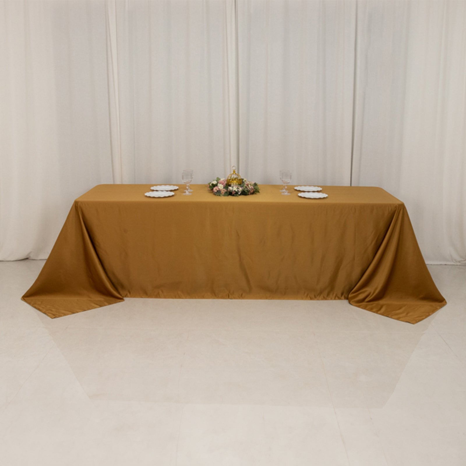 Gold seamless satin tablecloth for an 8-foot table with floor-length drop.