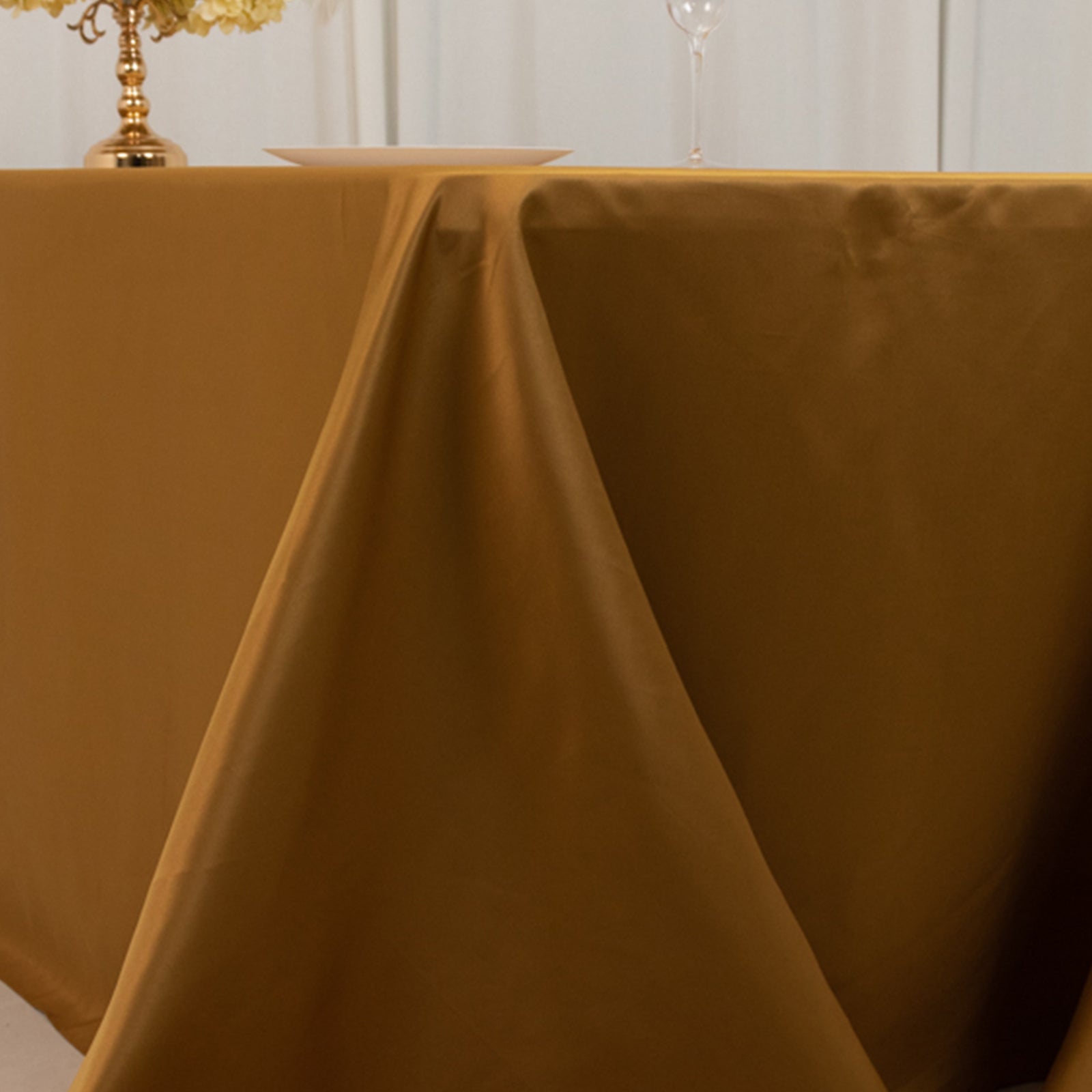 Gold seamless satin tablecloth for 8-foot table with floor-length drop.