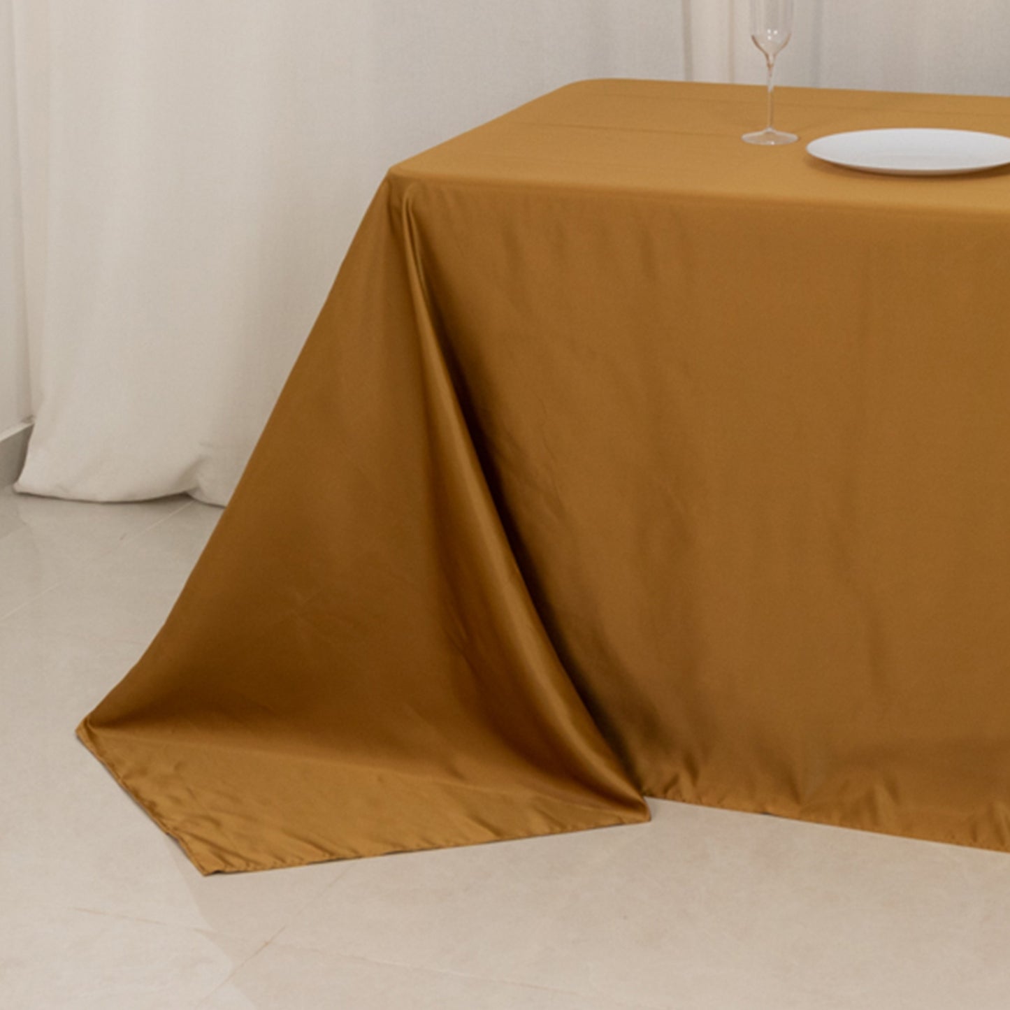 Gold seamless satin tablecloth for 8-foot table with floor-length drop.