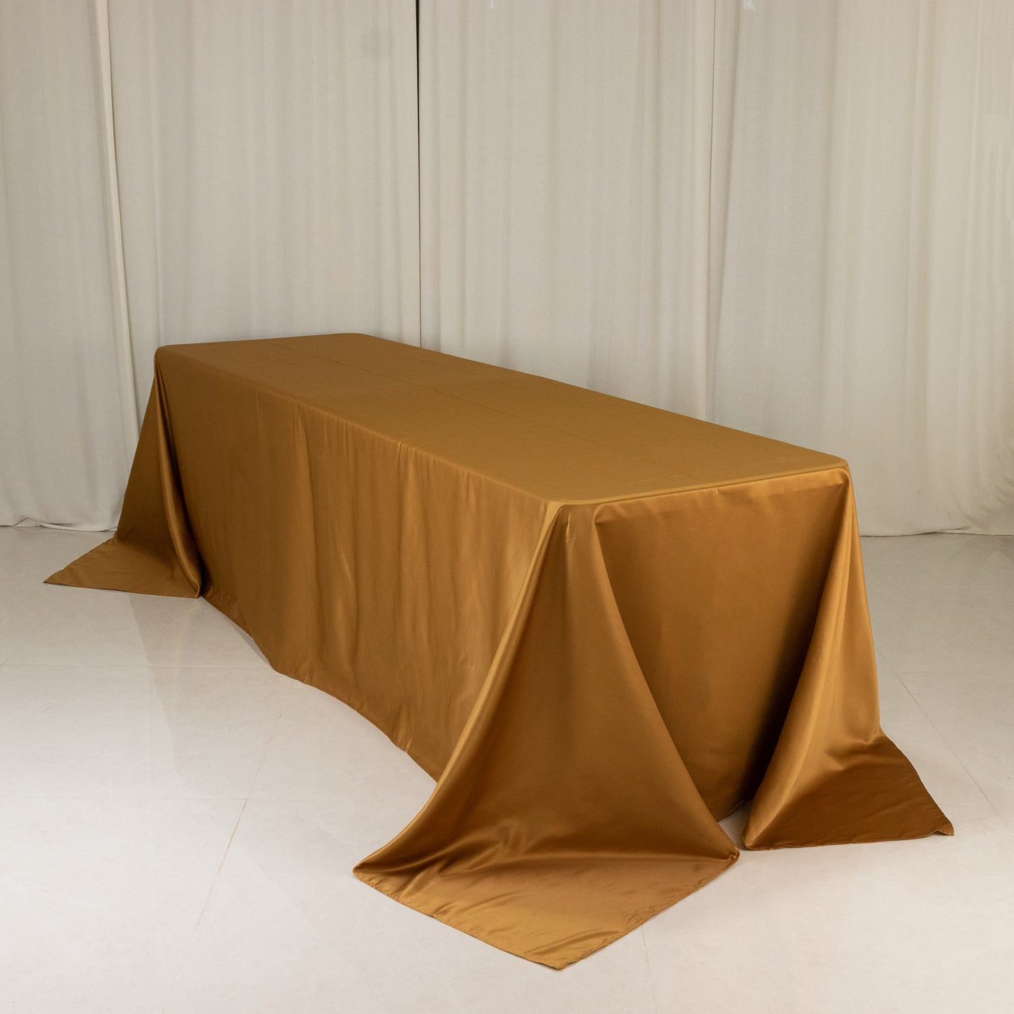 Gold rectangular tablecloth for 8-foot table with floor-length drop.