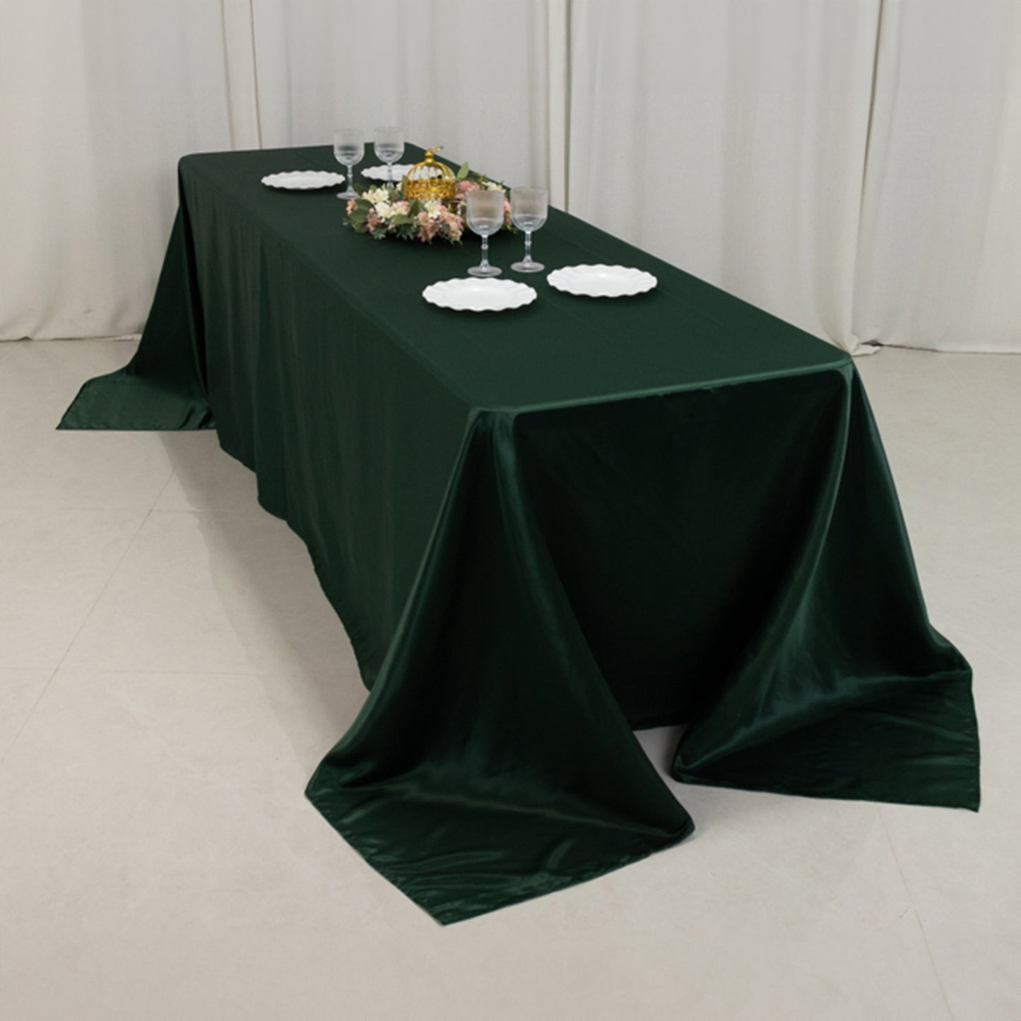 Emerald green satin tablecloth for 8-foot table with floor-length drop.