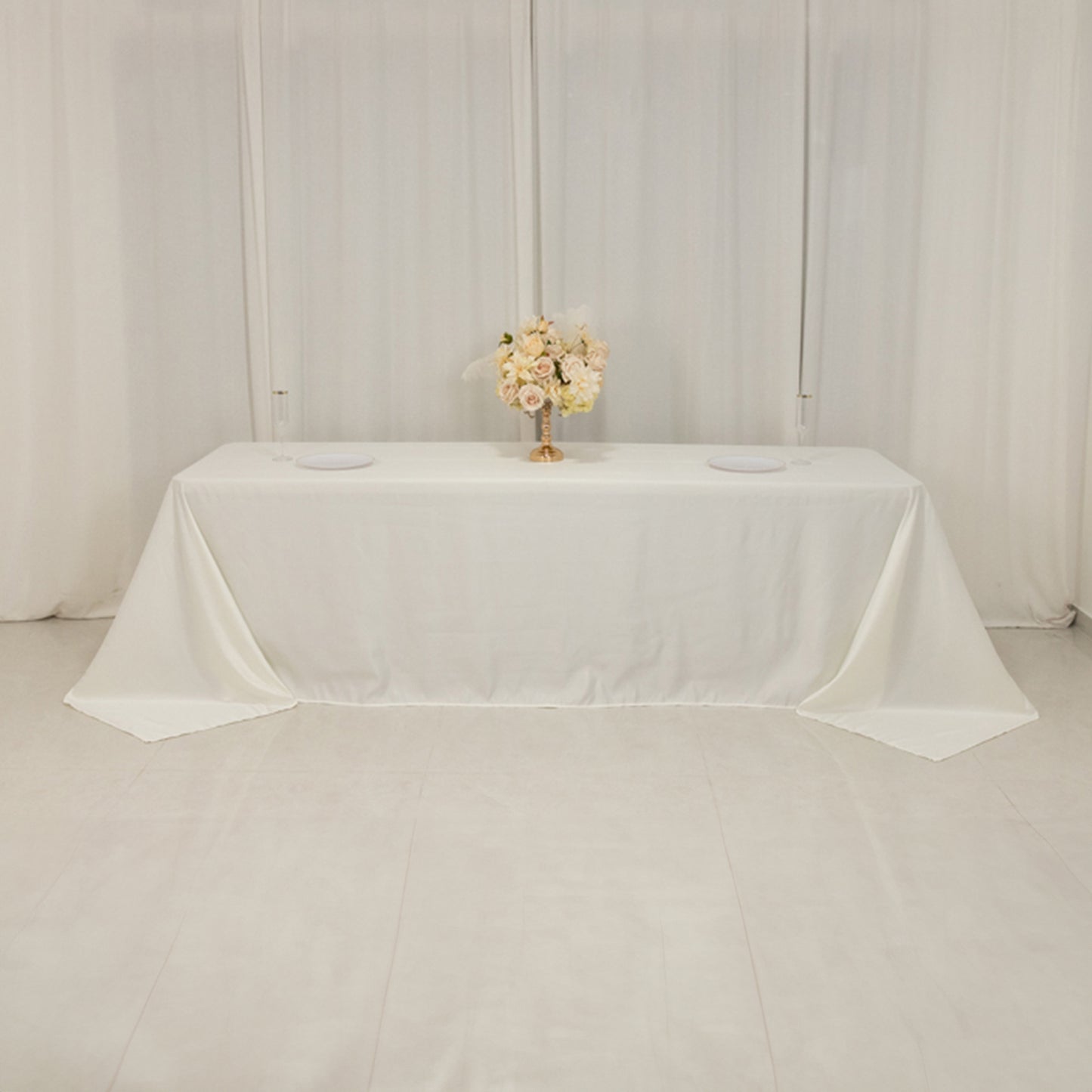 Ivory seamless satin tablecloth for 8-foot table with floor-length drop.
