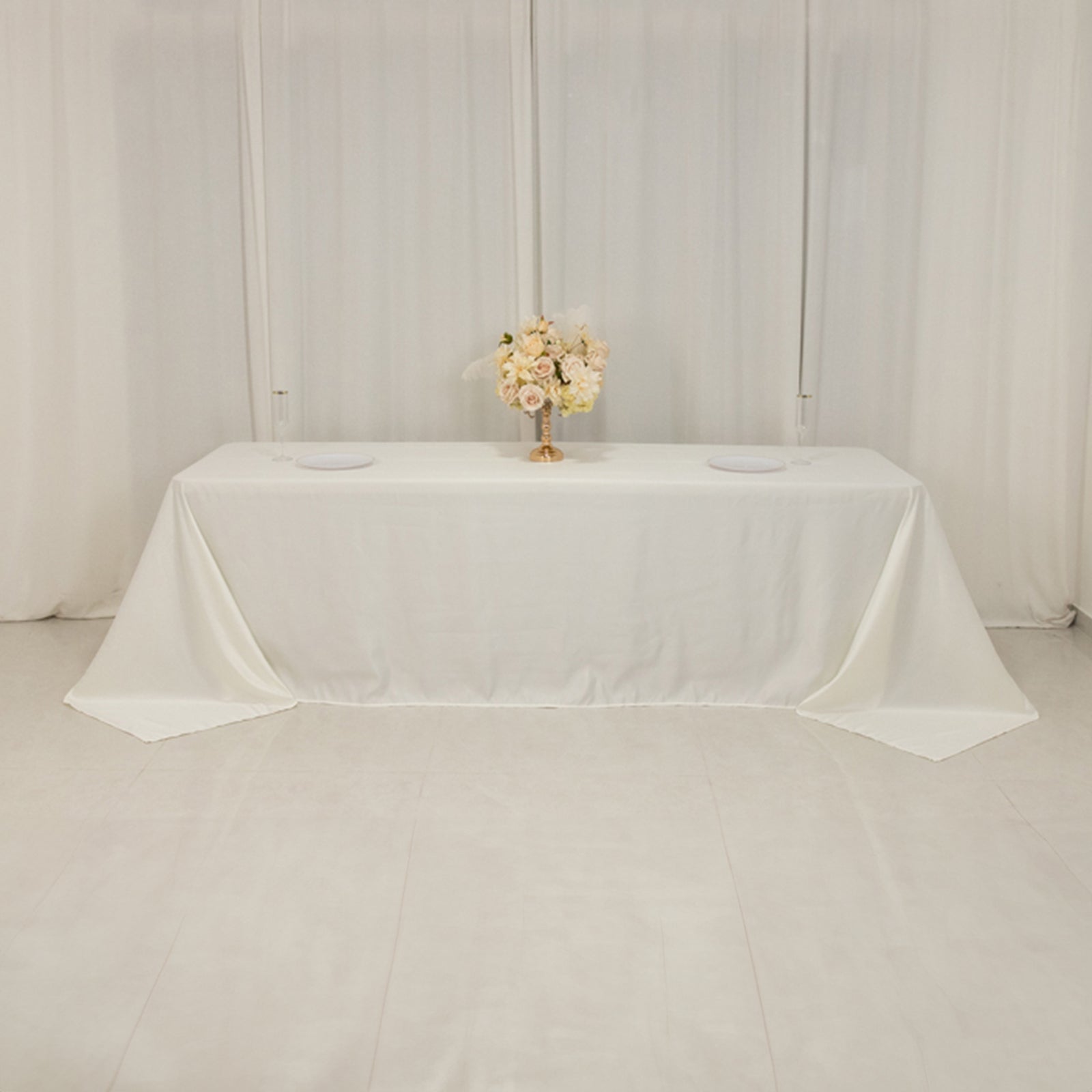 Ivory seamless satin tablecloth for 8-foot table with floor-length drop.