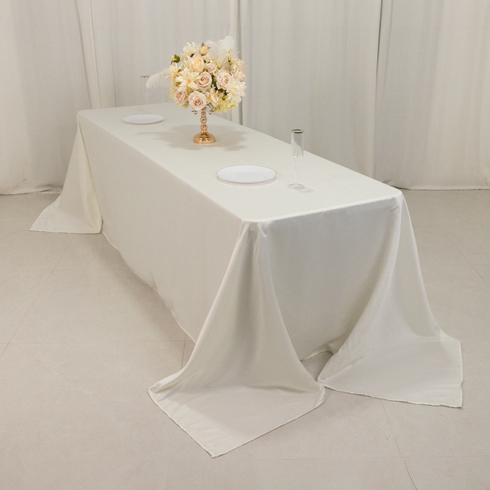 Ivory satin tablecloth for 8-foot table with floor-length drop.