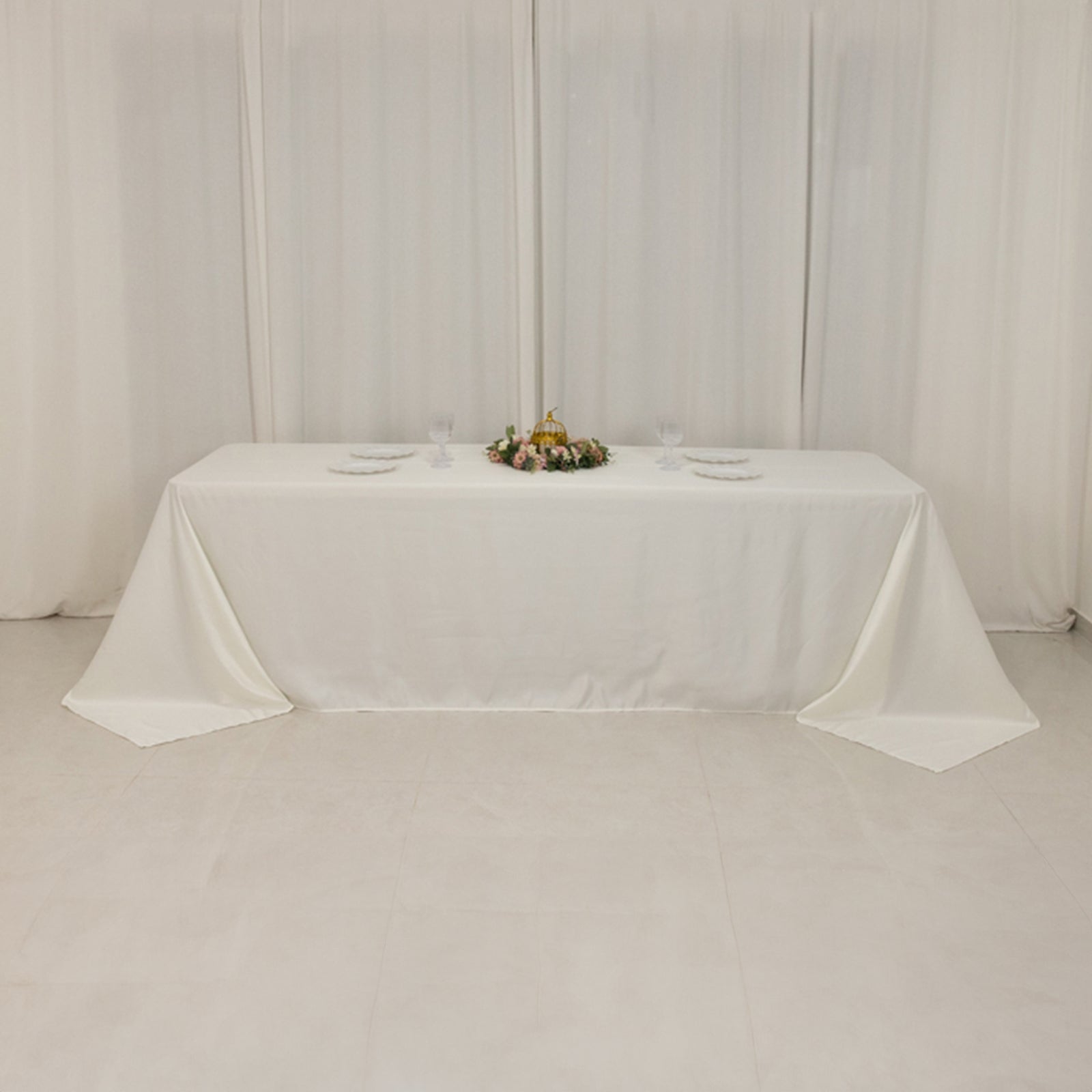 Ivory seamless satin tablecloth for 8-foot table with floor-length drop.