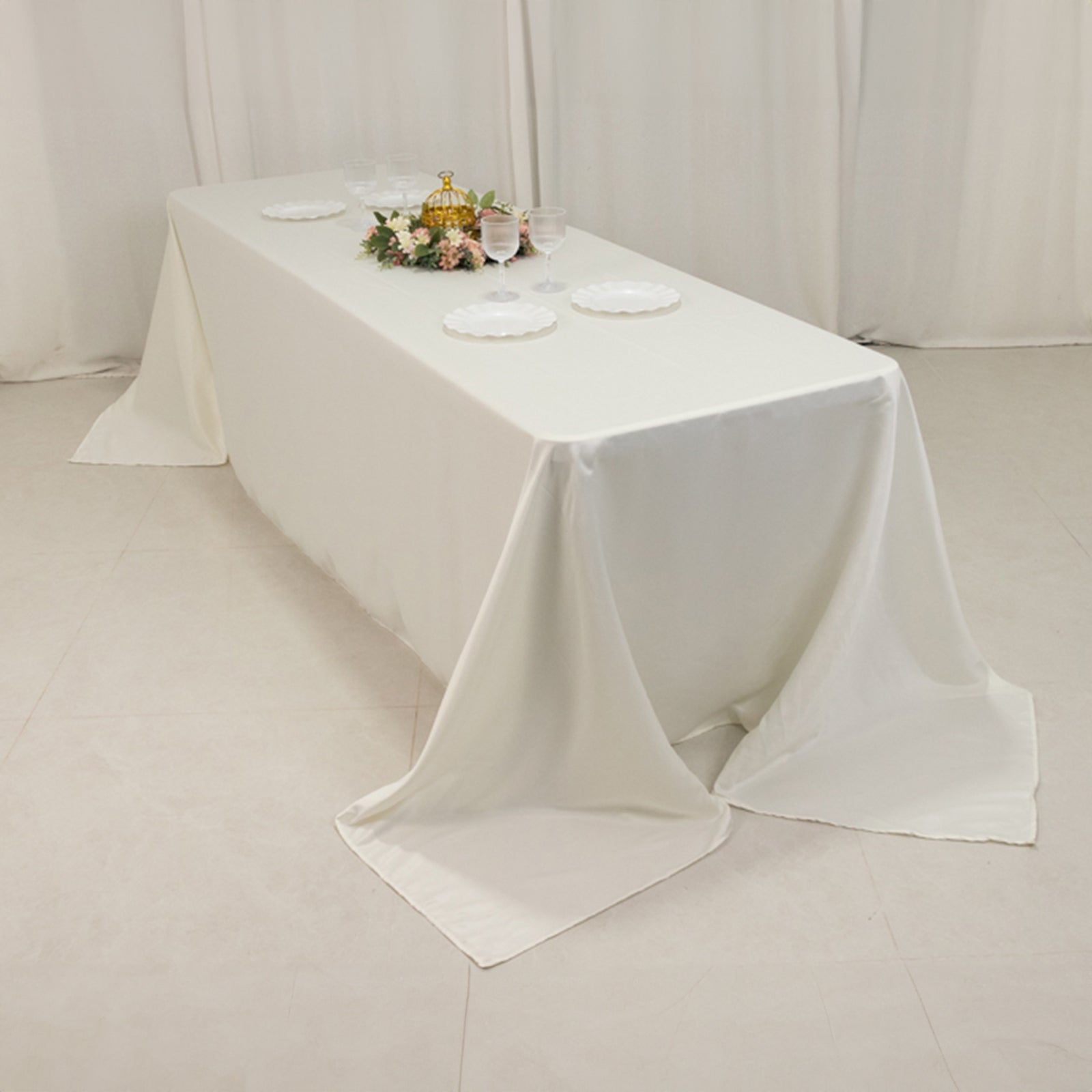 Ivory seamless satin tablecloth for 8-foot table with floor-length drop.