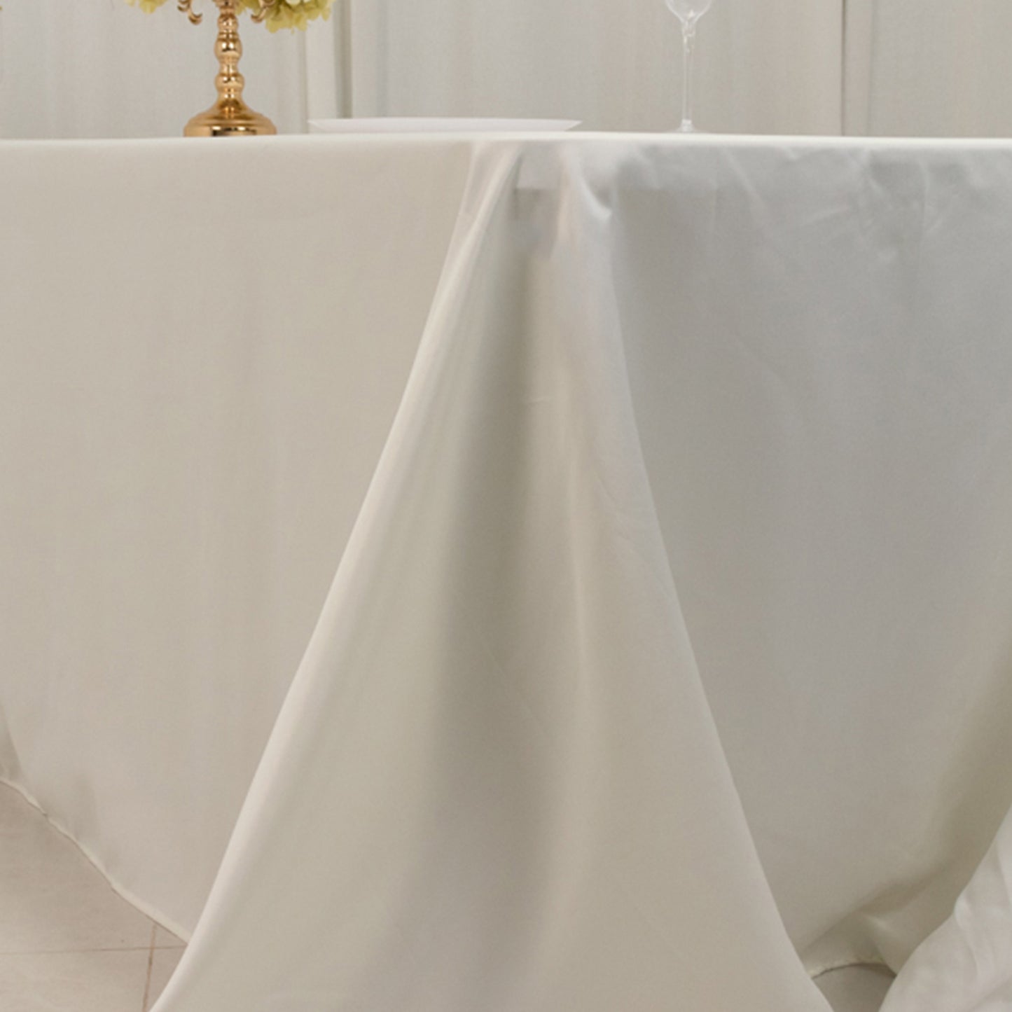 Ivory seamless satin tablecloth for 8-foot table with floor-length drop.