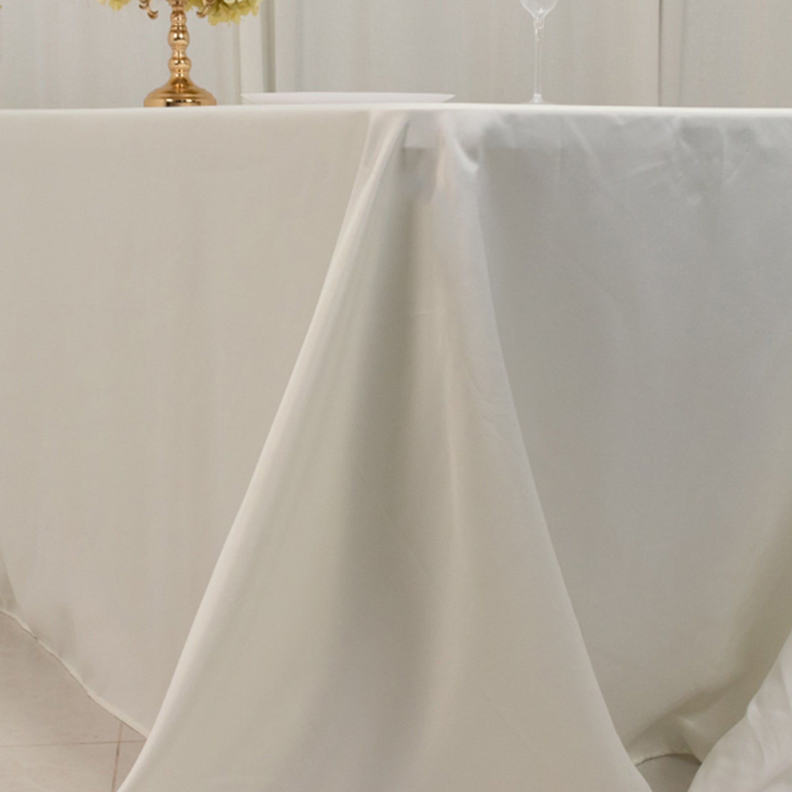 Ivory seamless satin tablecloth for 8-foot table with floor-length drop.