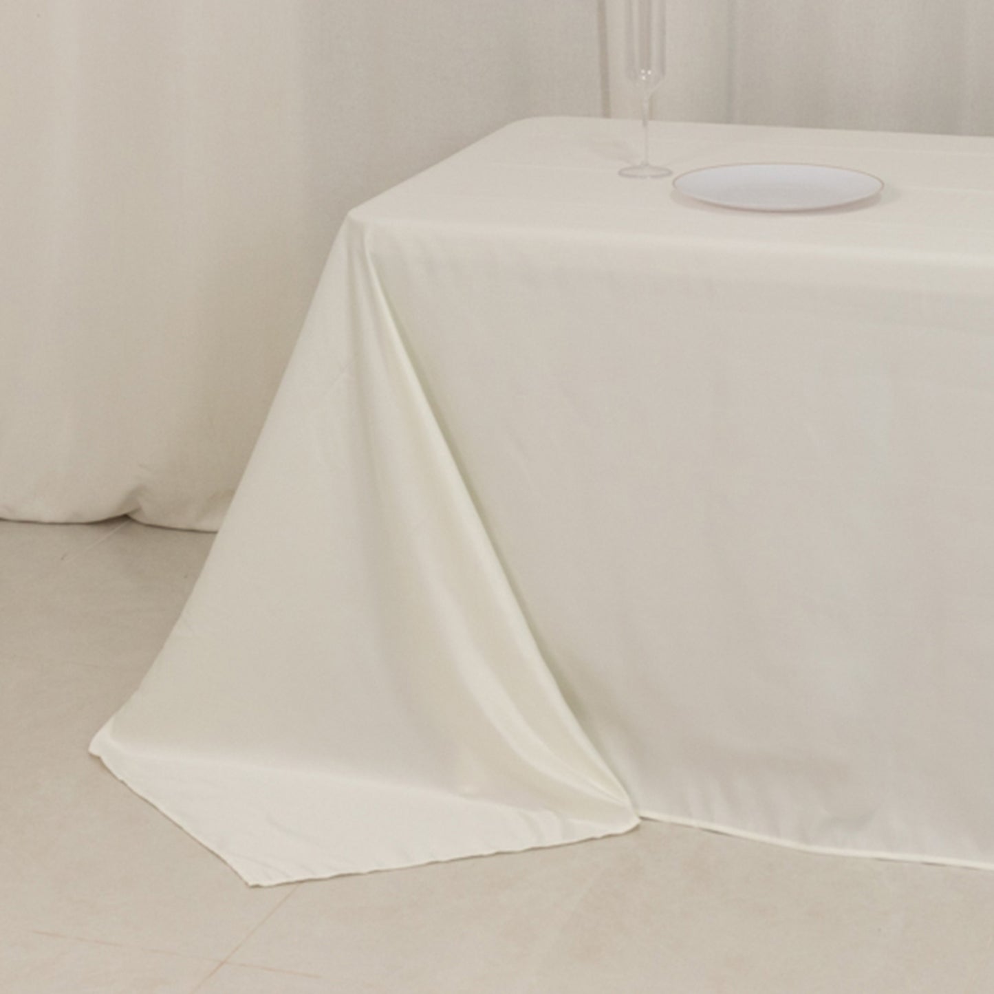 Ivory seamless satin tablecloth for 8-foot table with floor-length drop.