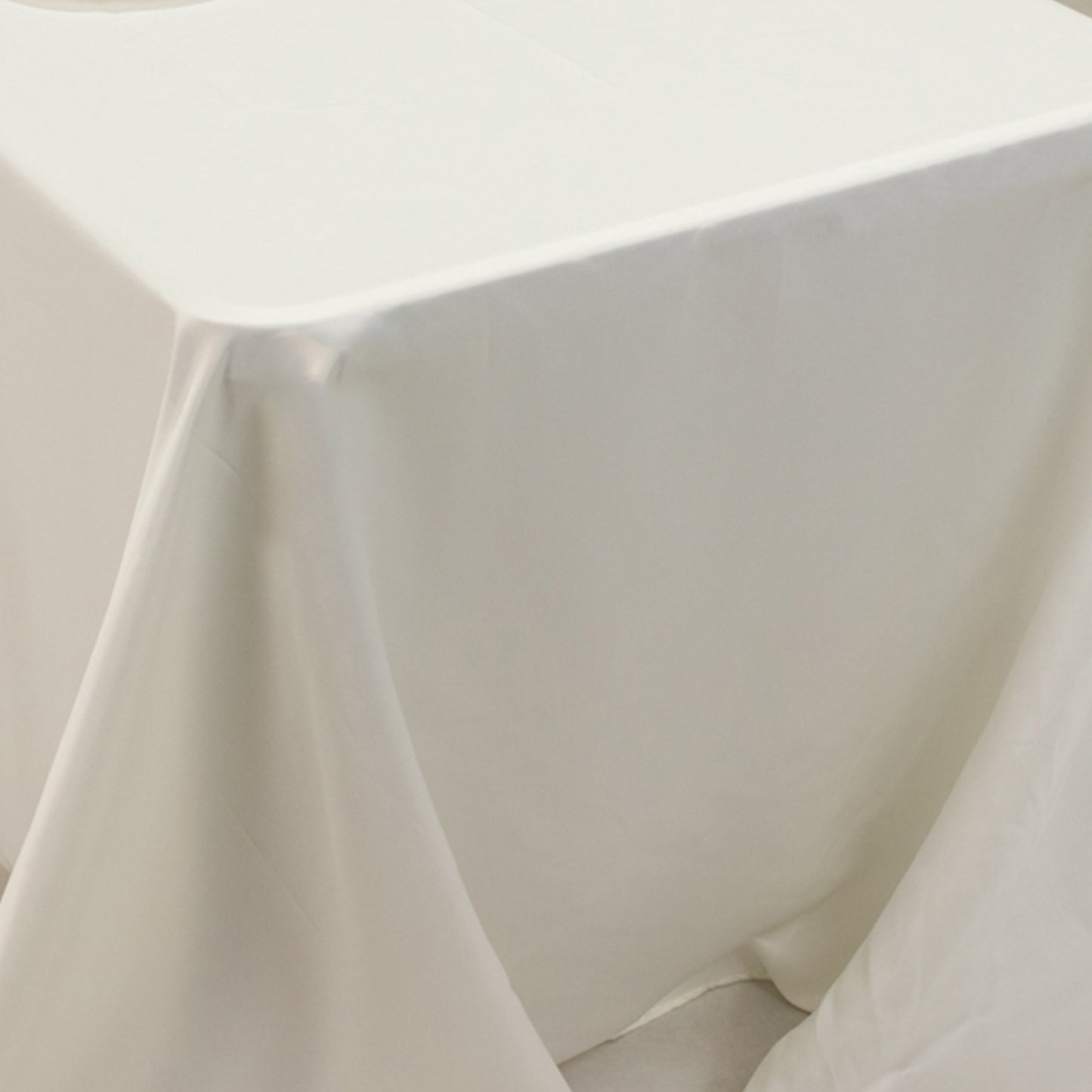 Ivory seamless satin tablecloth for 8-foot table with floor-length drop.