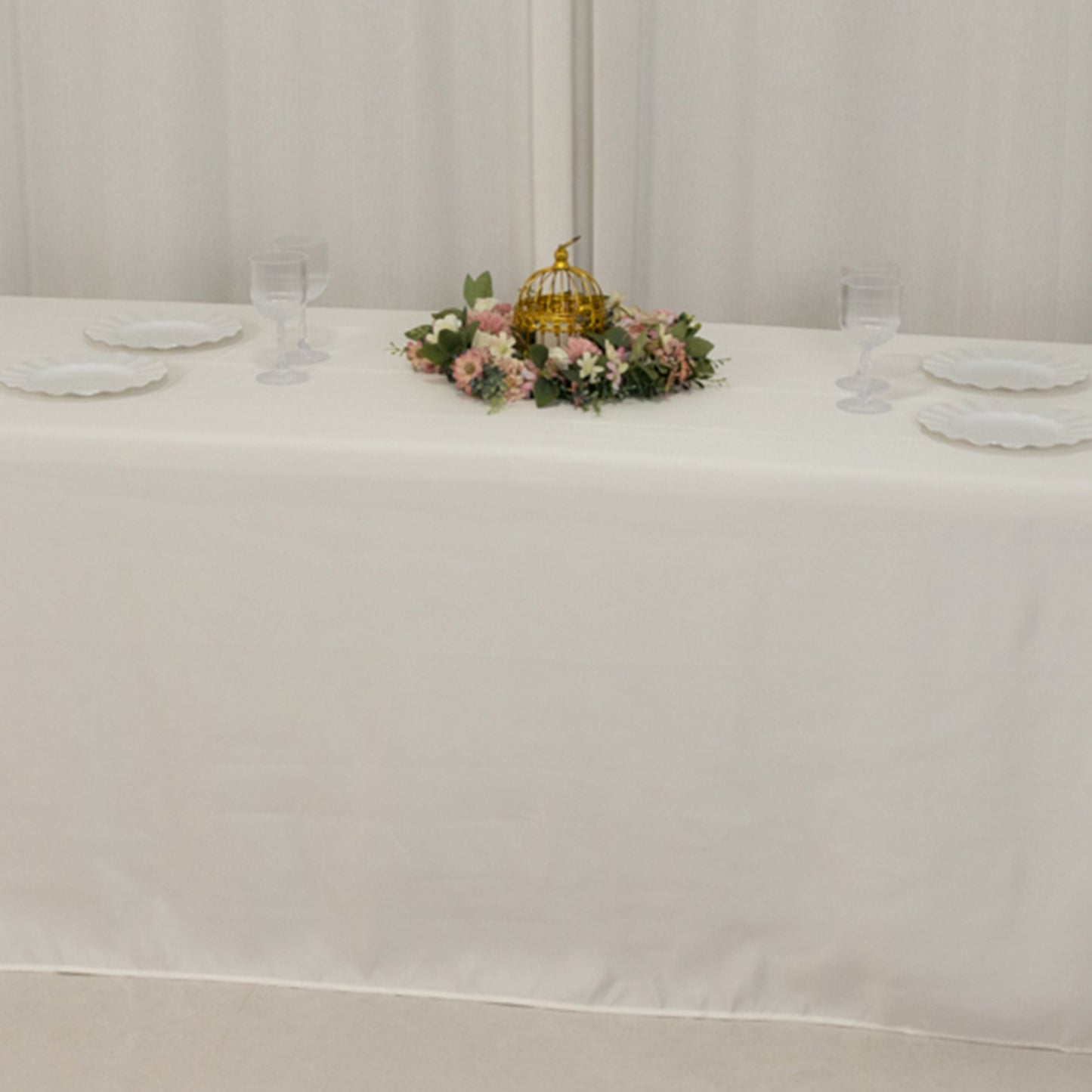 Ivory satin tablecloth for 8-foot table with floral centerpiece.