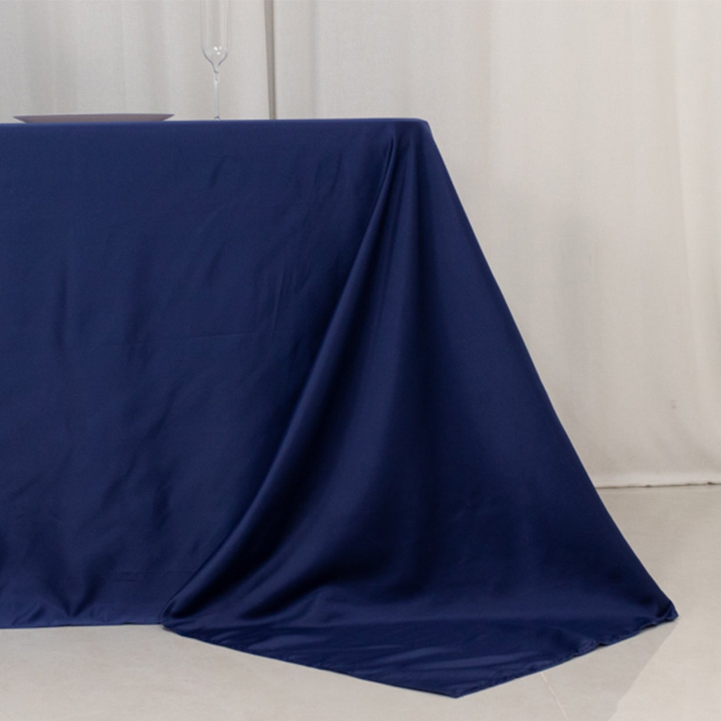 Navy blue satin tablecloth for 8-foot table with floor-length drop.