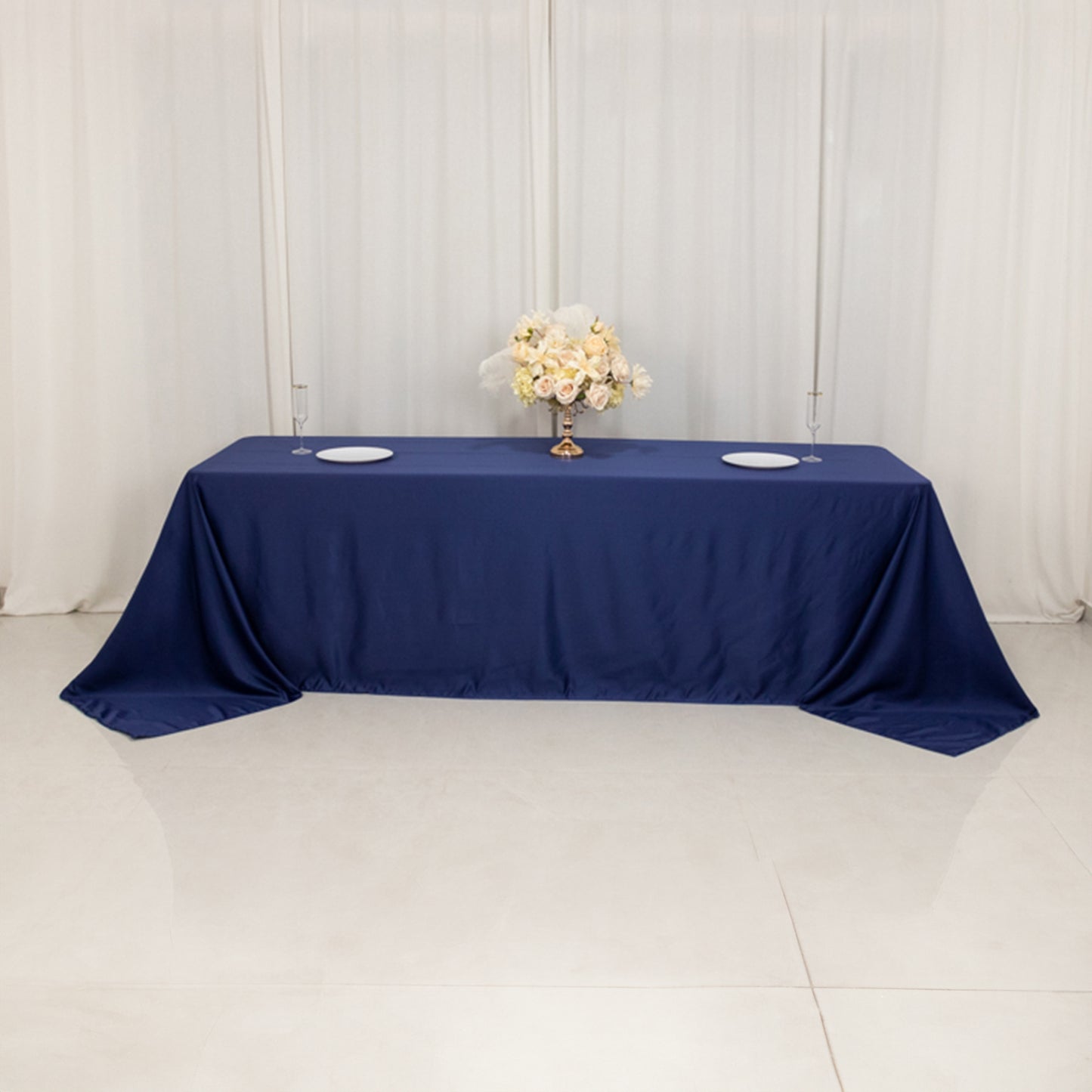Navy blue seamless satin tablecloth for 8-foot table with floor-length drop.