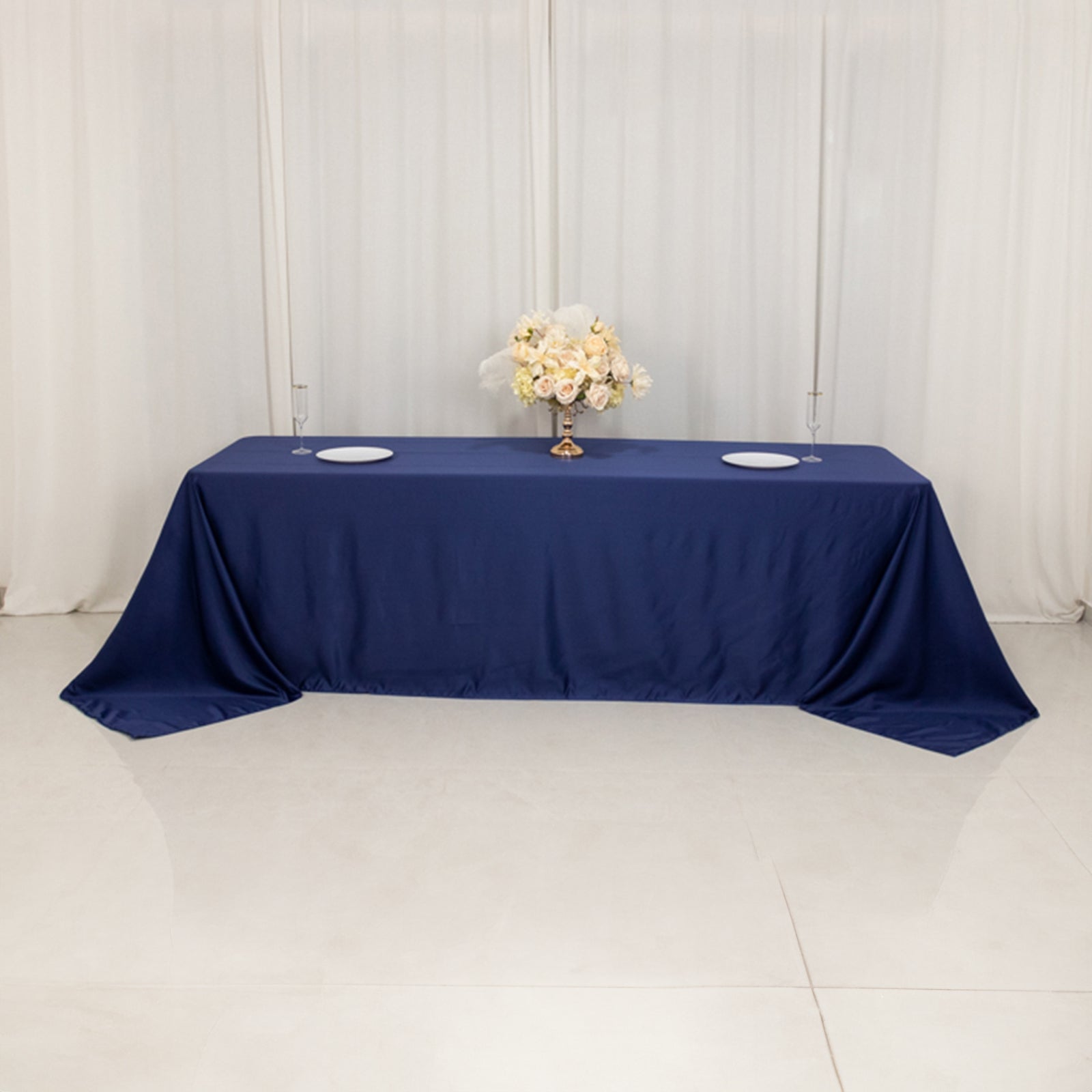 Navy blue seamless satin tablecloth for 8-foot table with floor-length drop.