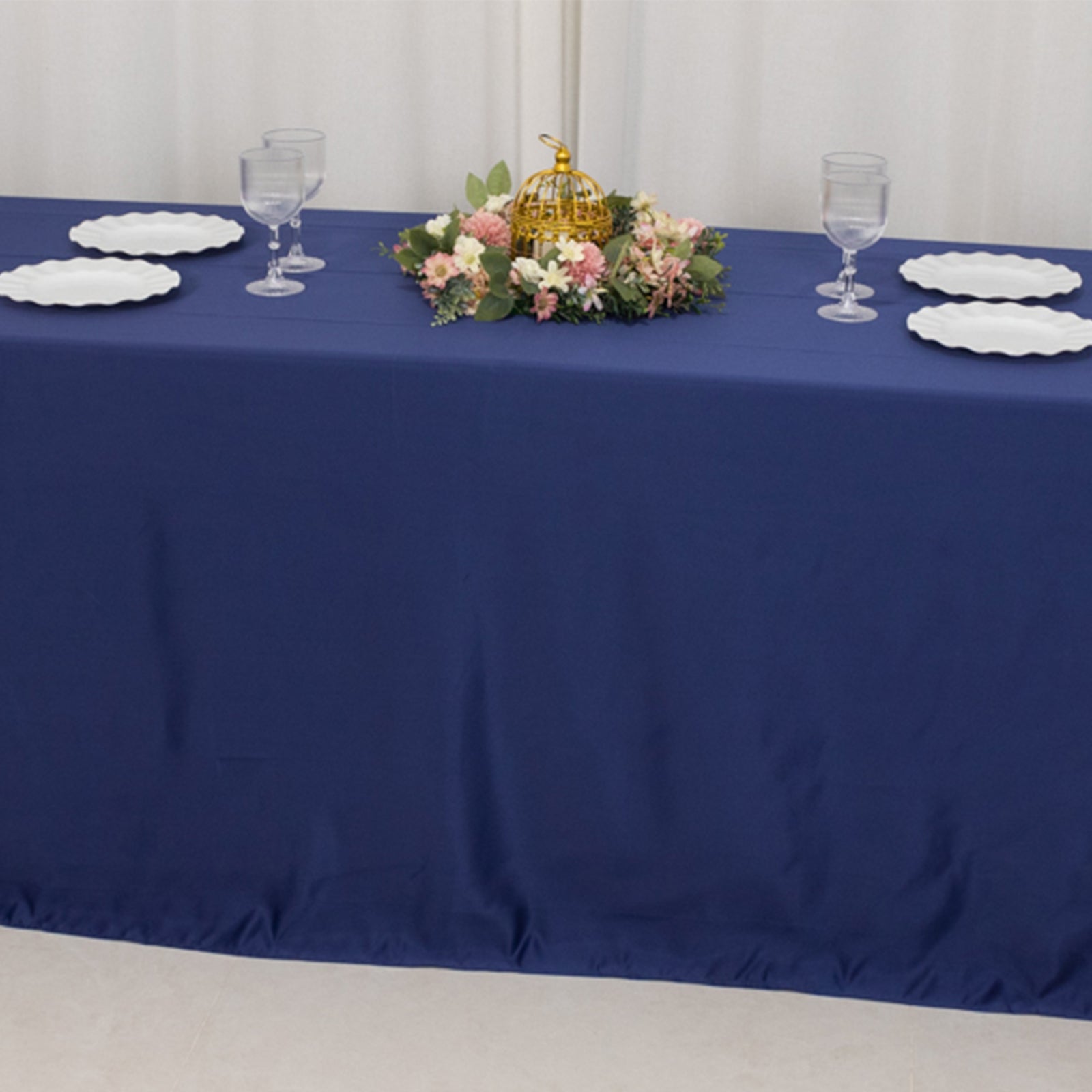 Navy blue seamless satin tablecloth for 8-foot table with floor-length drop.